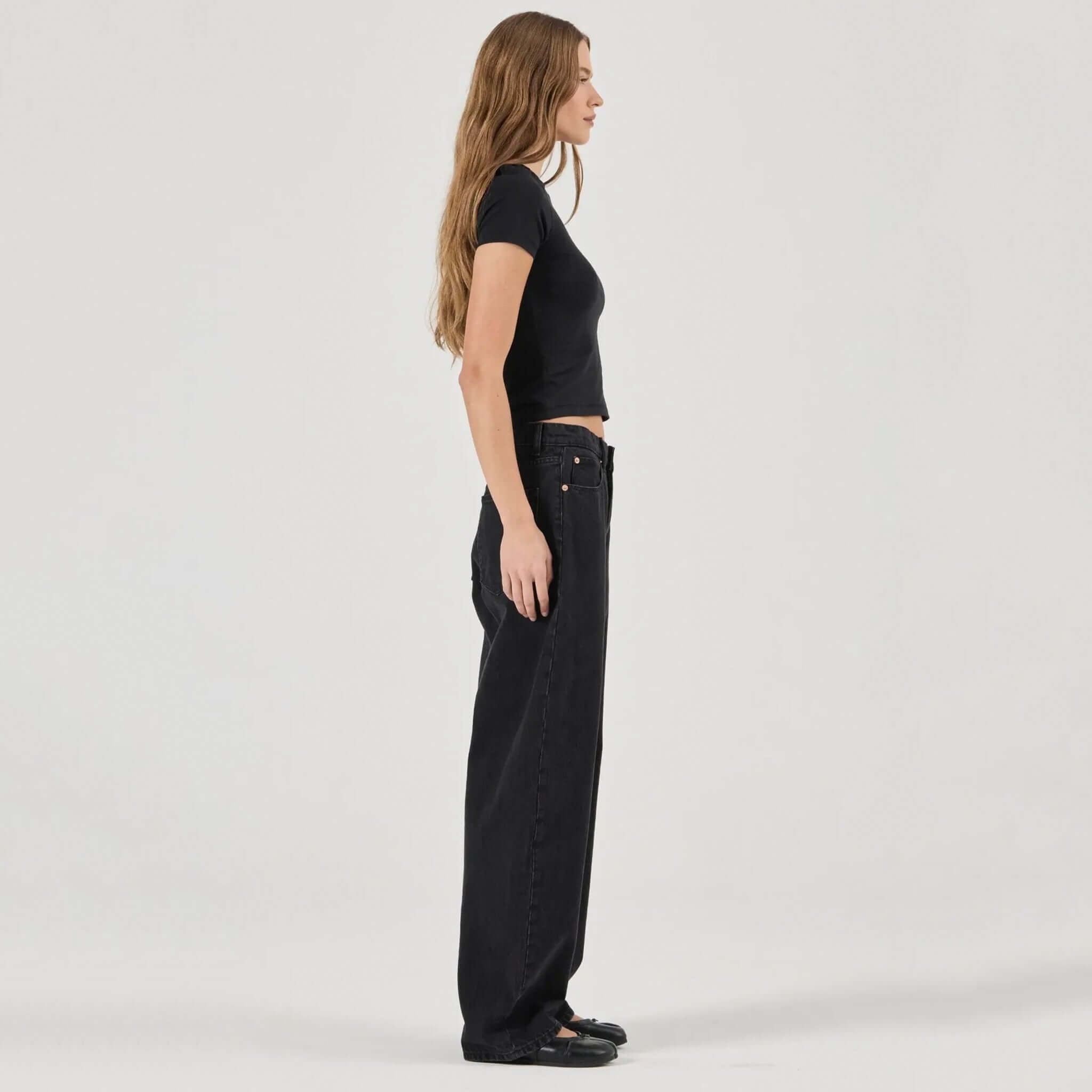 Alt Tag: Rolla's Arc Barrel Jeans - Black Sand side view on model, mid-rise relaxed barrel leg black sand cotton denim