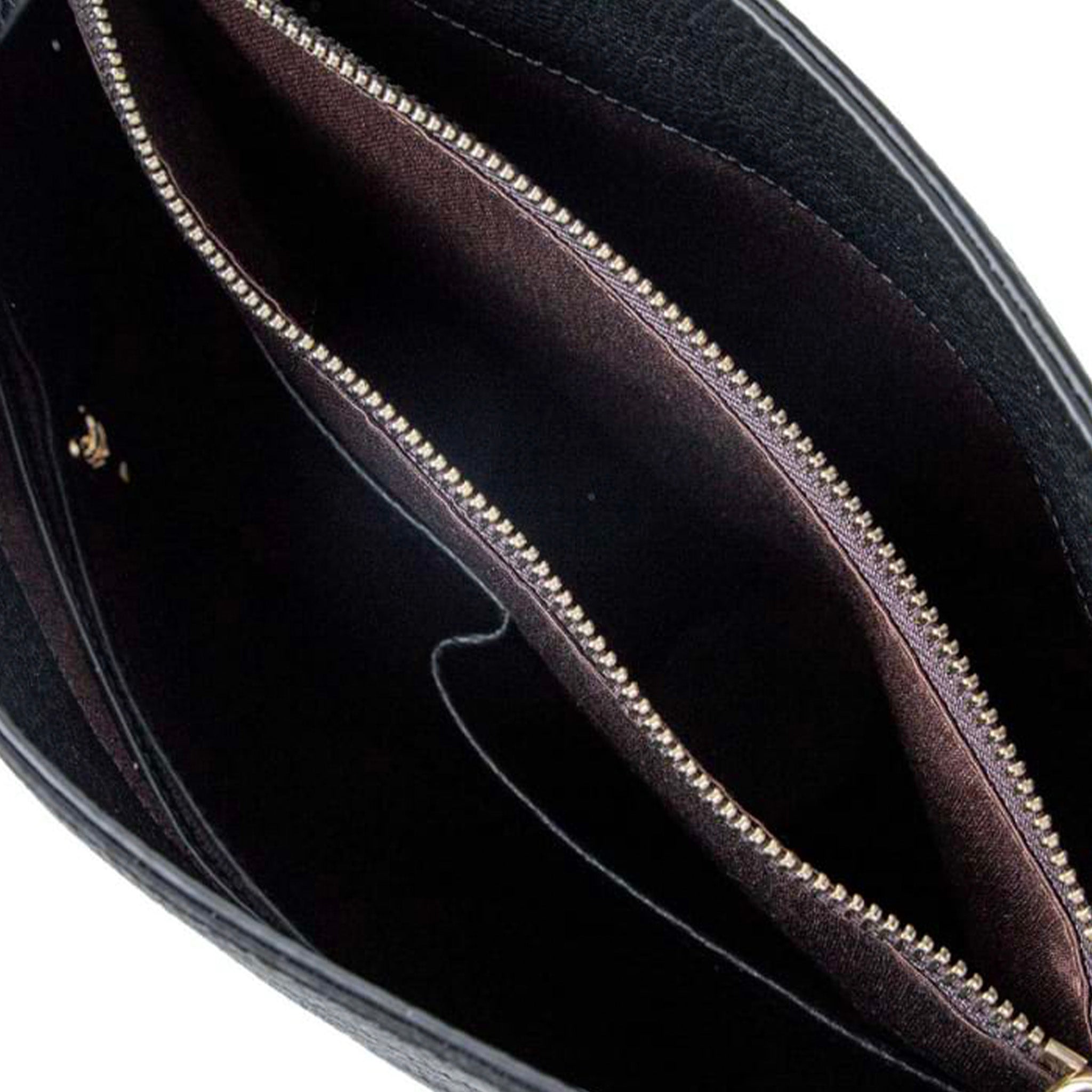 Close-up of a black handbag with a gold zipper on a white background