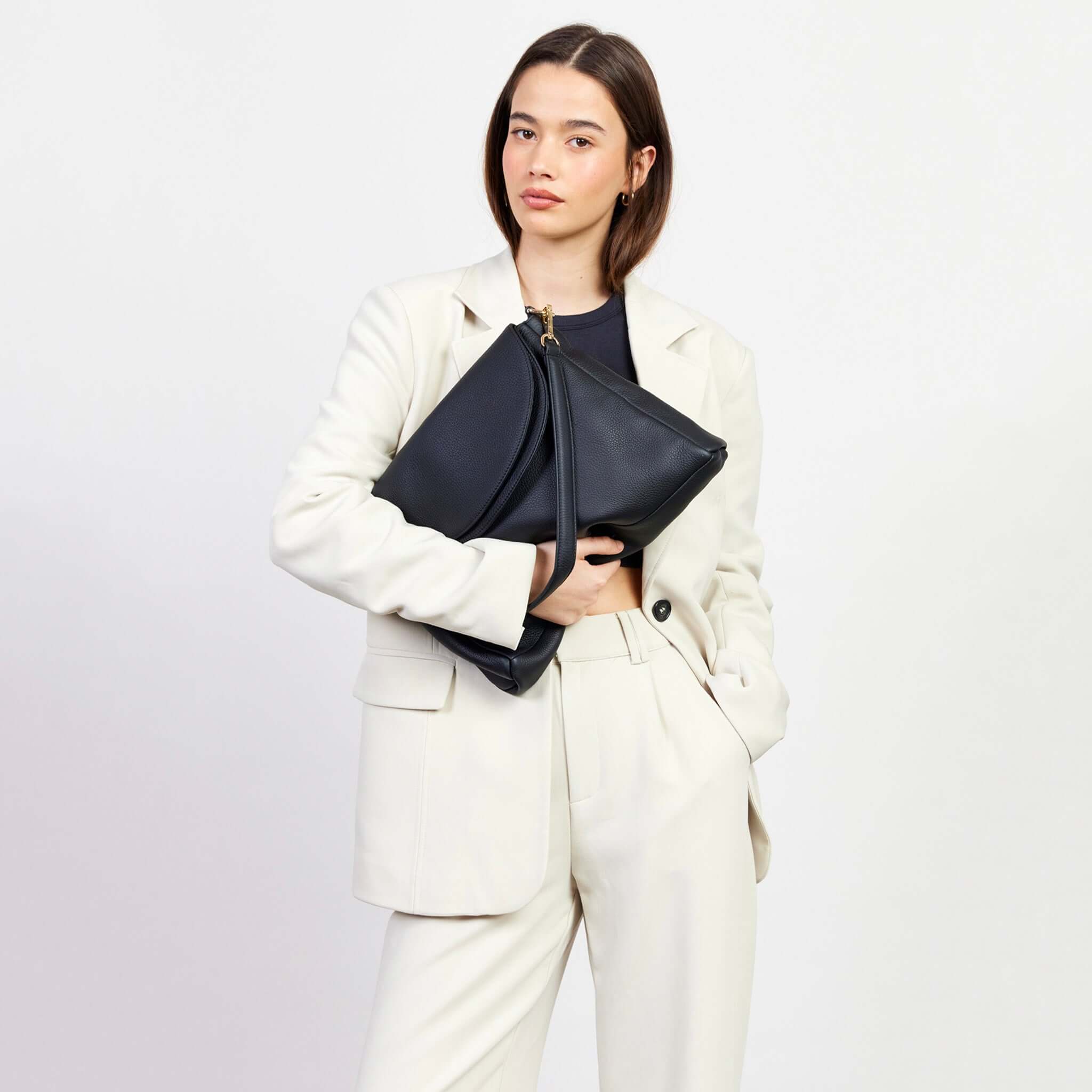 Alt Tag: Saben Becks Shoulder Bag - Black Luxe soft luxe black leather draped shoulder bag with foldover panels, worn by model