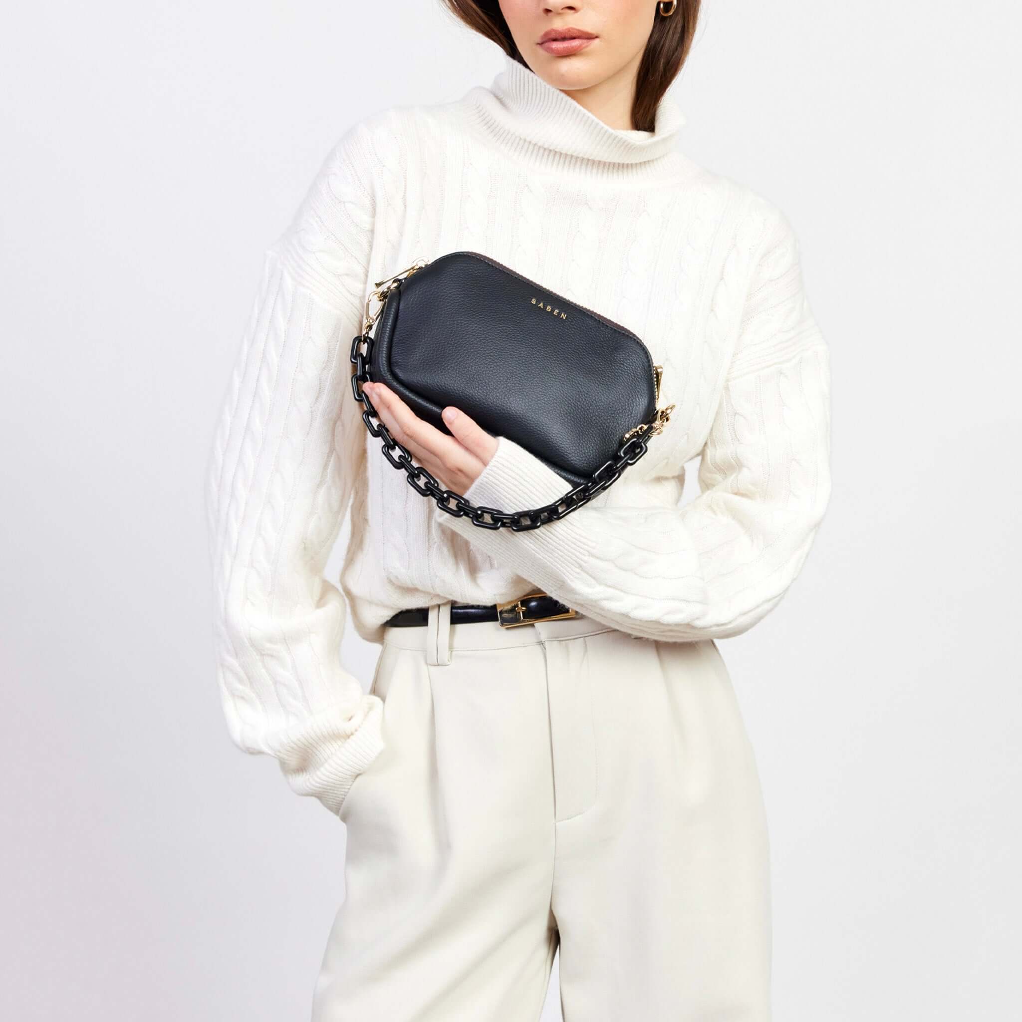 Saben Feature Chain Handle - Black Chunky on black clutch bag, worn as chunky chain handle wristlet for a glitzy look