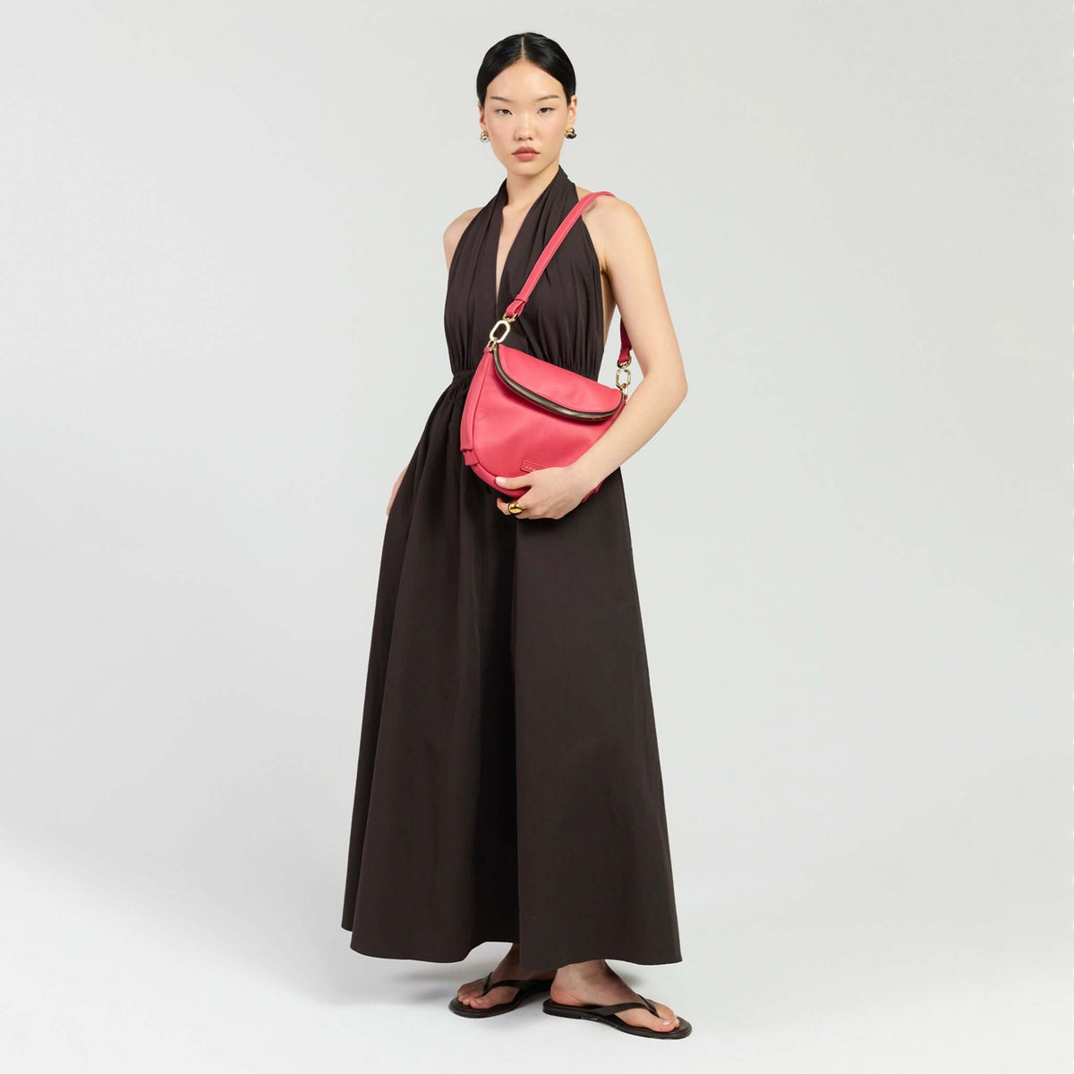 Model showcasing the Saben Fifi Crossbody Bag - Azalea with a chic outfit in a minimalistic setting.