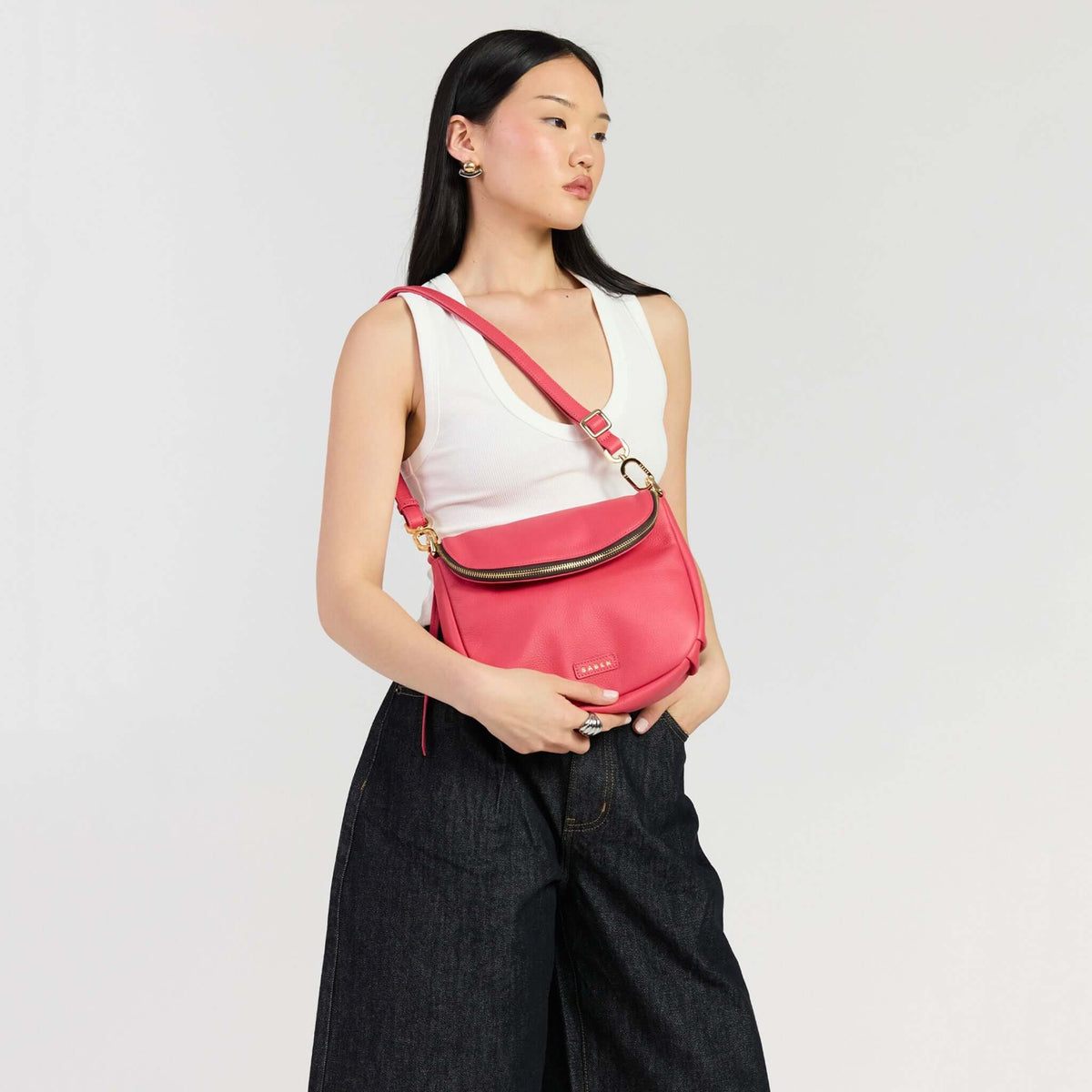 Model showcasing the Saben Fifi Crossbody Bag - Azalea, featuring a compact design and chic style.