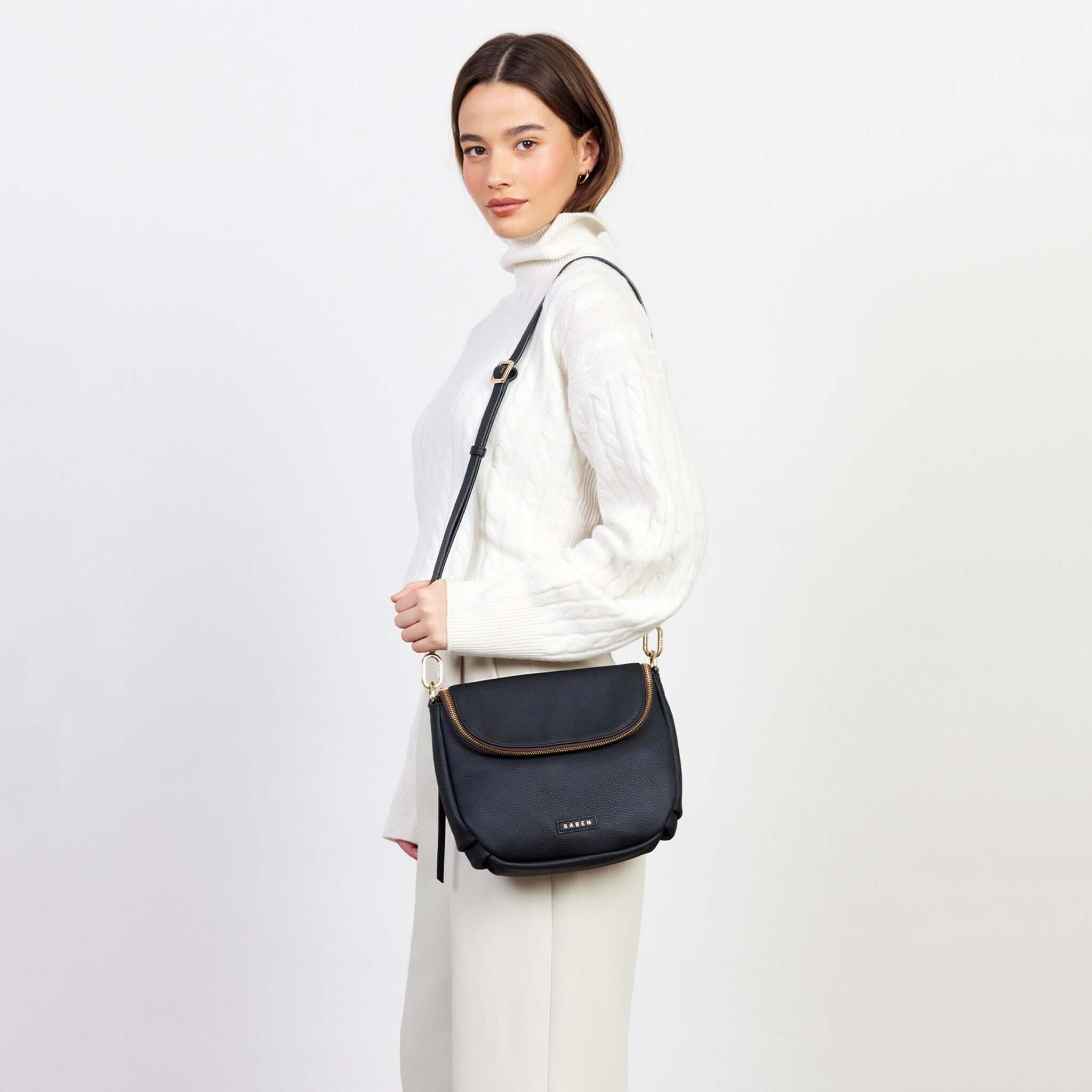 Alt Tag: Saben Fifi Crossbody Bag - Black worn crossbody on model, black pebbled leather with draped pocket detail