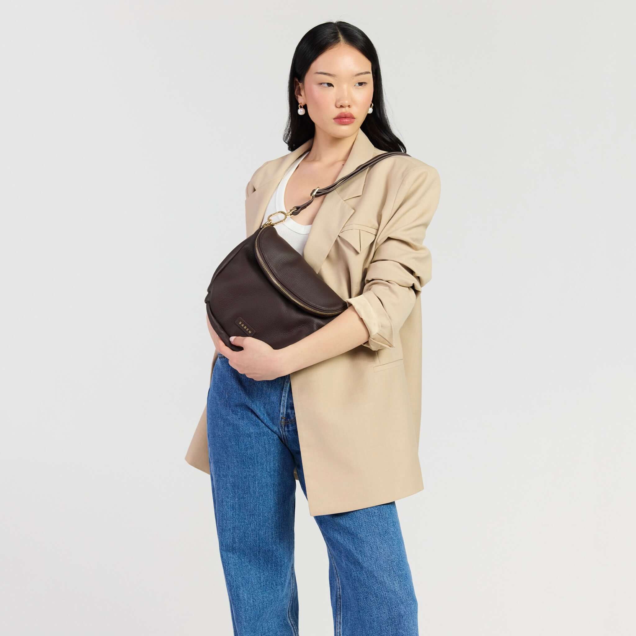 Saben Fifi Crossbody Bag - Cacao showcased in a stylish outfit, featuring soft pebbled leather and a chic design.