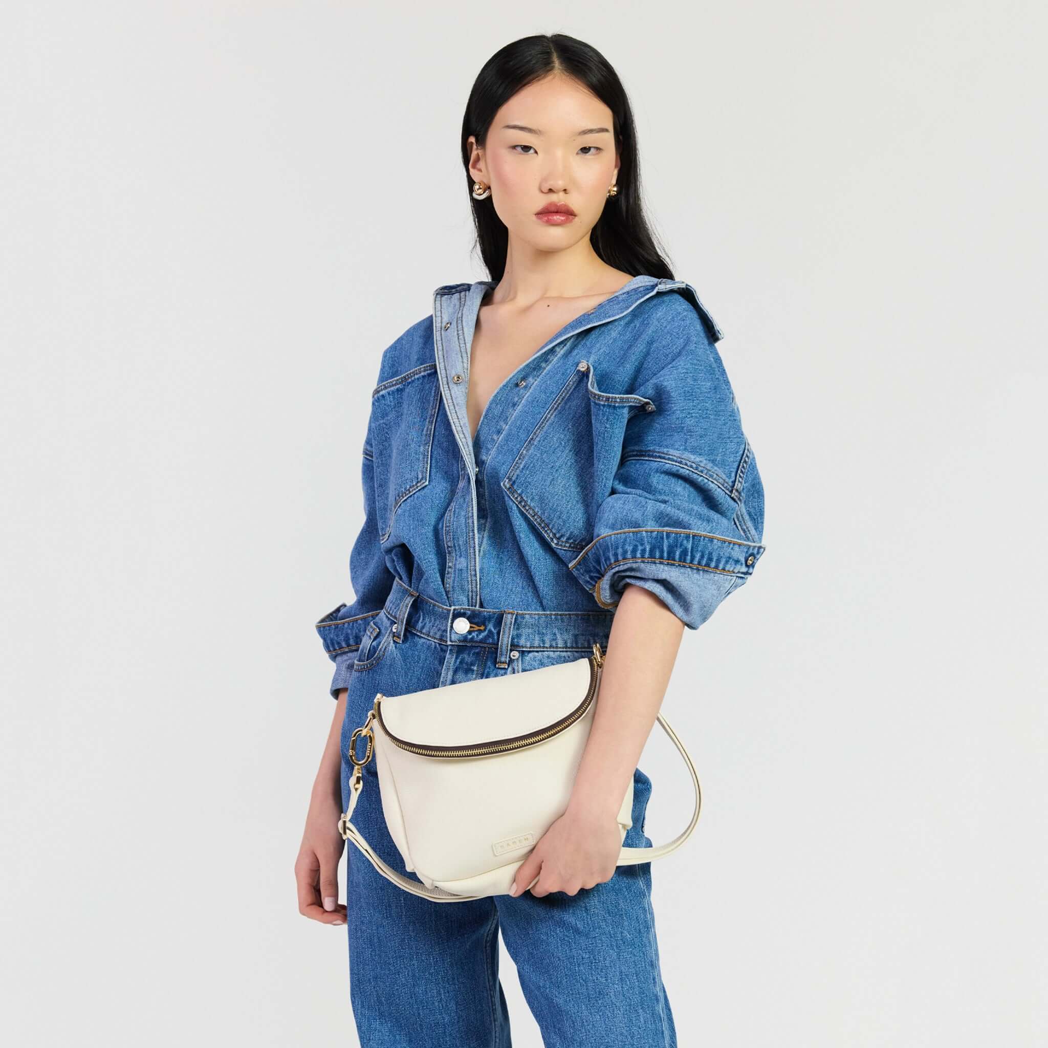 Model wearing Saben Fifi Crossbody Bag - Quartz with denim outfit, showcasing chic and compact design.