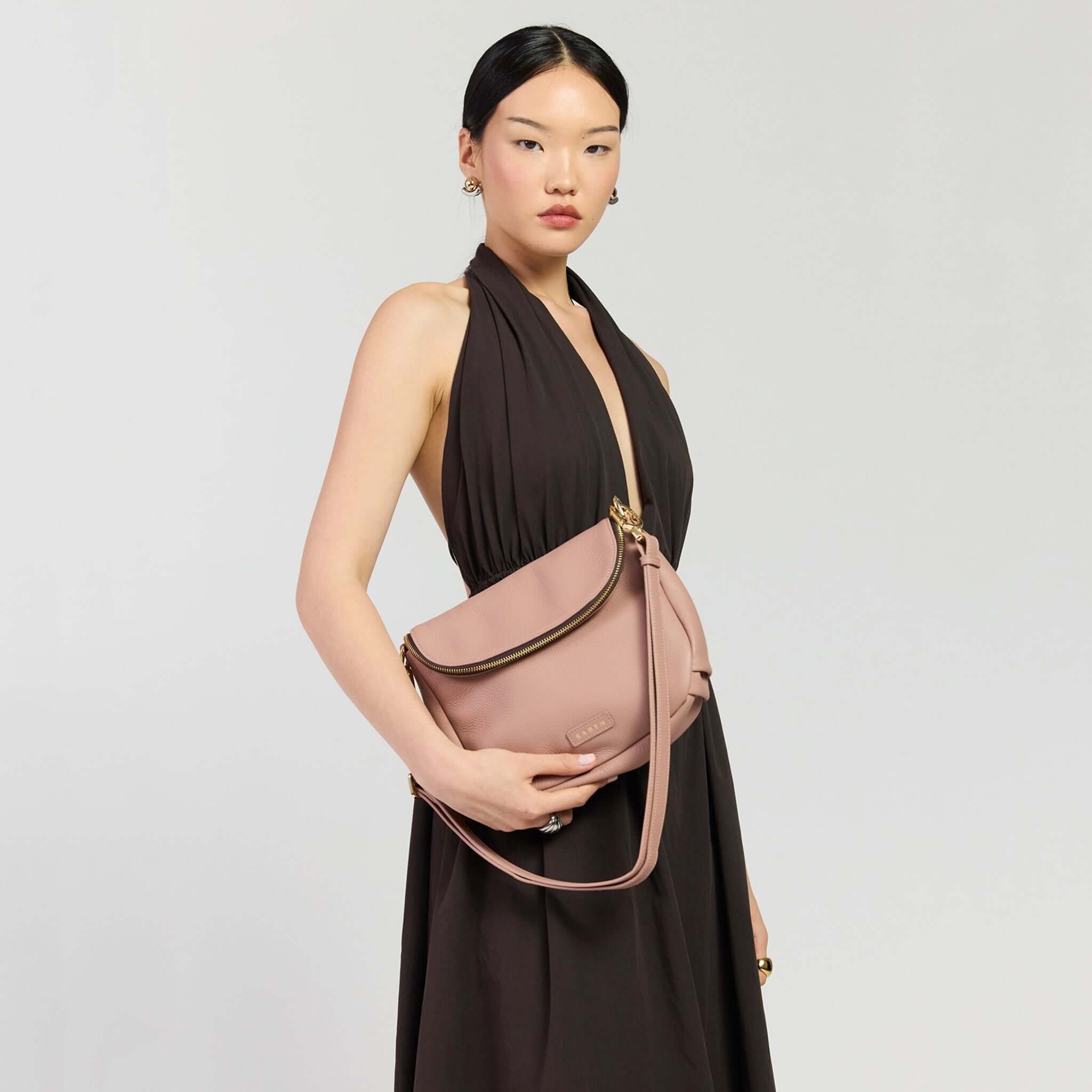 Saben Fifi Crossbody Bag - Rosewater worn by a model in a chic dress showcasing its stylish design.