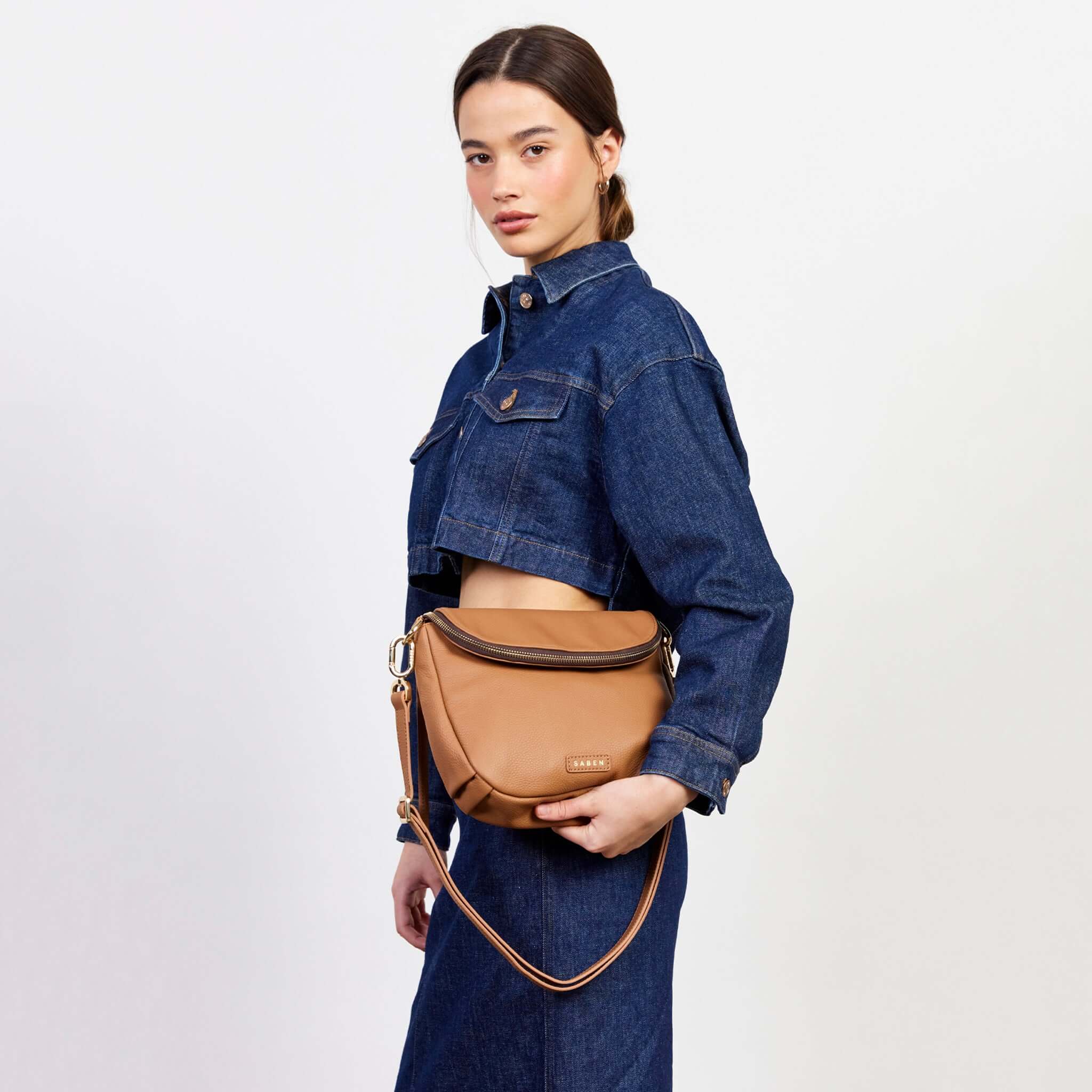 Alt Tag: Saben Fifi Crossbody Bag - Toffee worn crossbody on model, compact pebbled leather bag with draped pocket detail