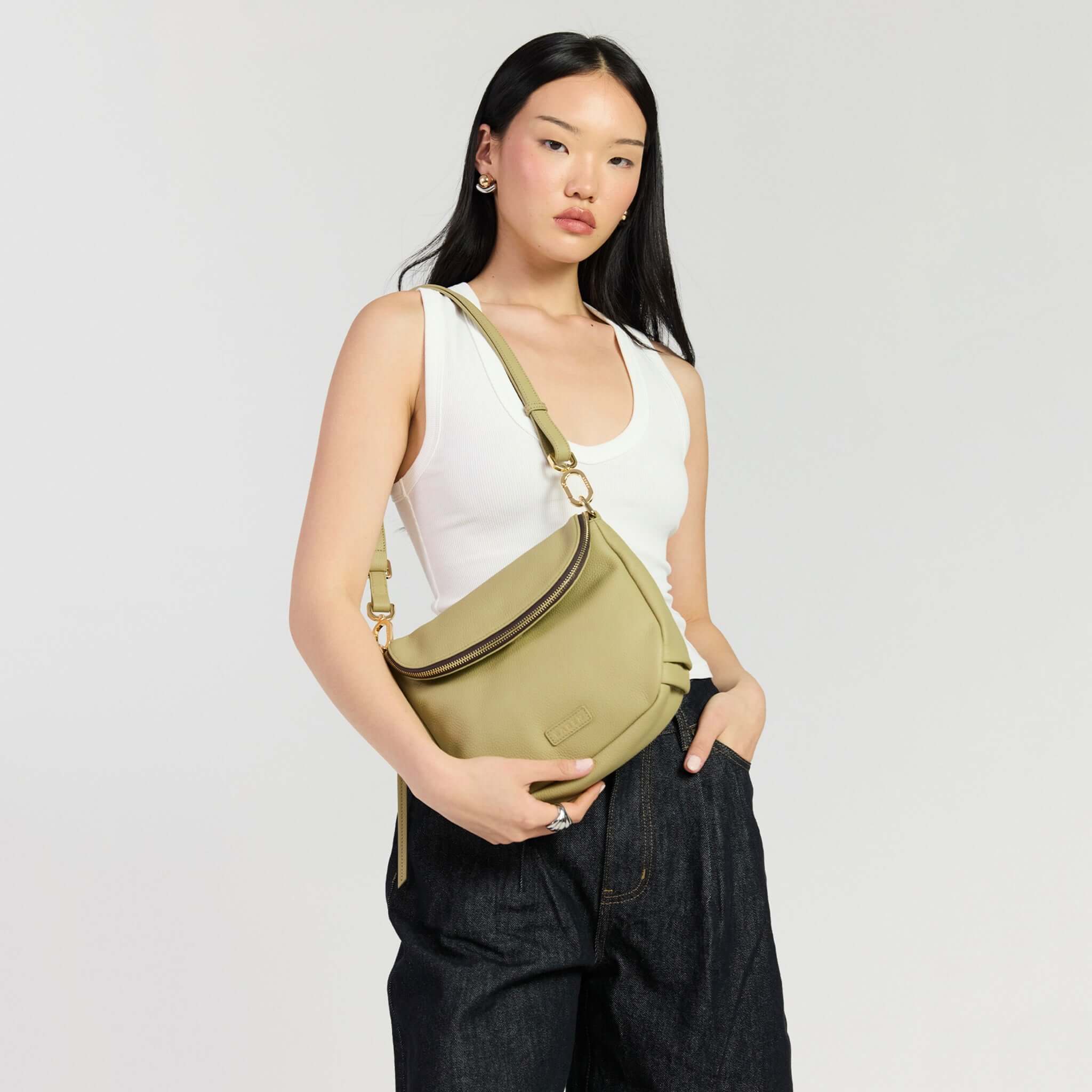 Saben Fifi Crossbody Bag - Willow showcased on a model featuring chic design and soft pebbled leather.