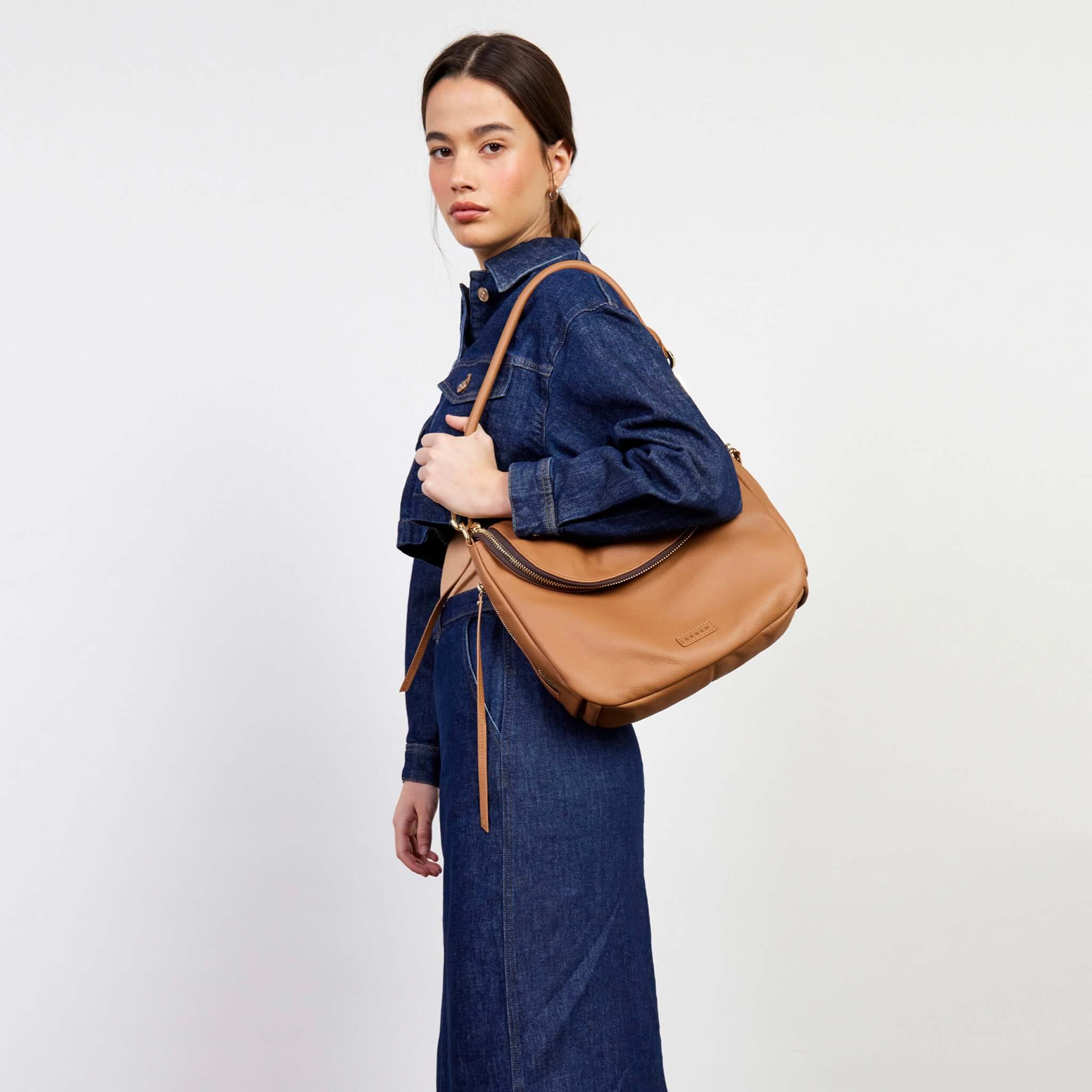 Alt Tag: Saben Frankie Shoulder Bag - Toffee slouchy pebbled leather shoulder bag with front zip compartment, worn on shoulder