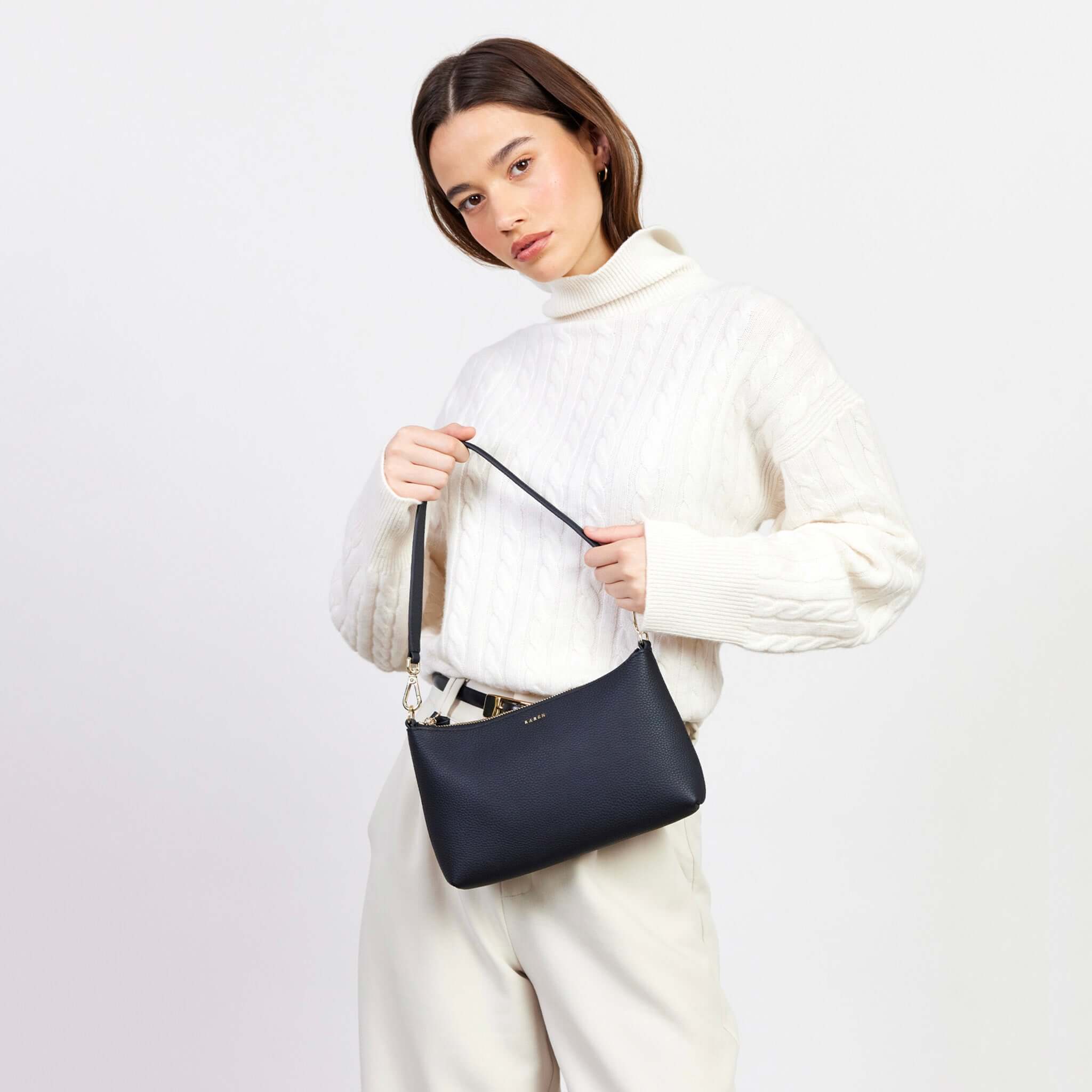 Alt Tag: Saben Haven Shoulder Bag - Black Dipped on model, compact black shoulder bag with strap, ideal for nights out and brunch