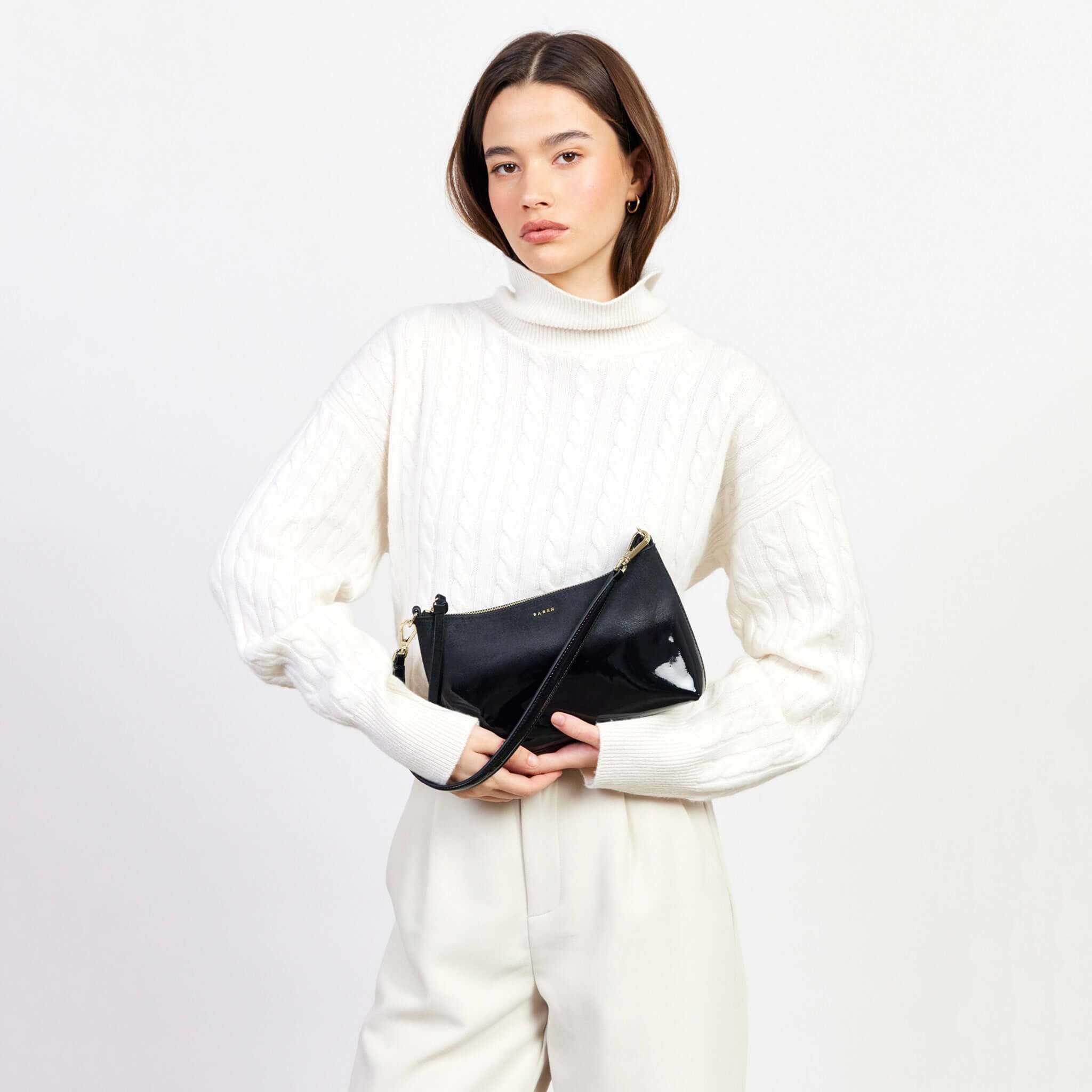 Alt Tag: Saben Haven Shoulder Bag - Black Dipped worn crossbody by model, compact black shoulder bag with strap for nights out