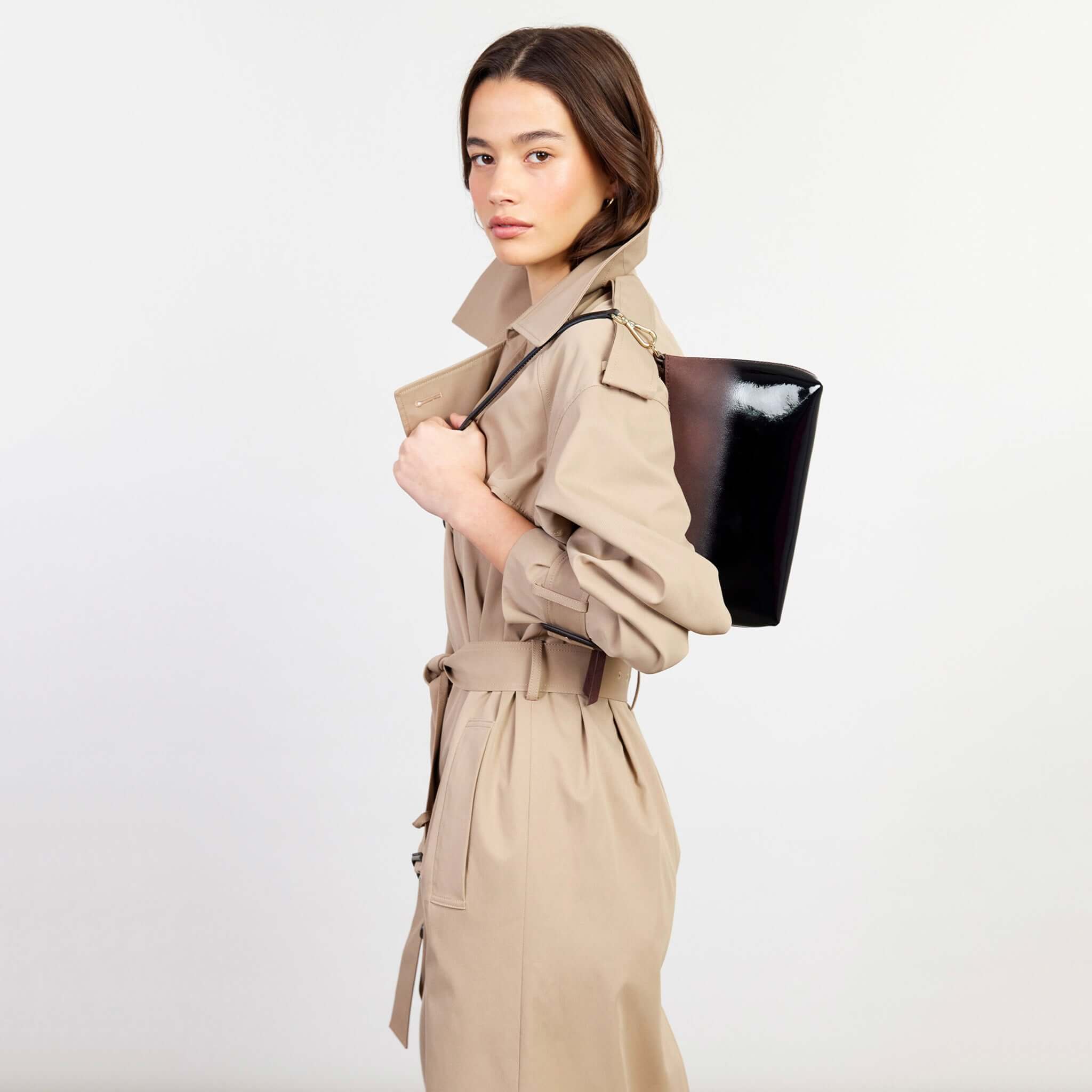Saben Haven Shoulder Bag - Espresso Dipped worn on shoulder by model, compact glossy leather evening bag with adjustable strap