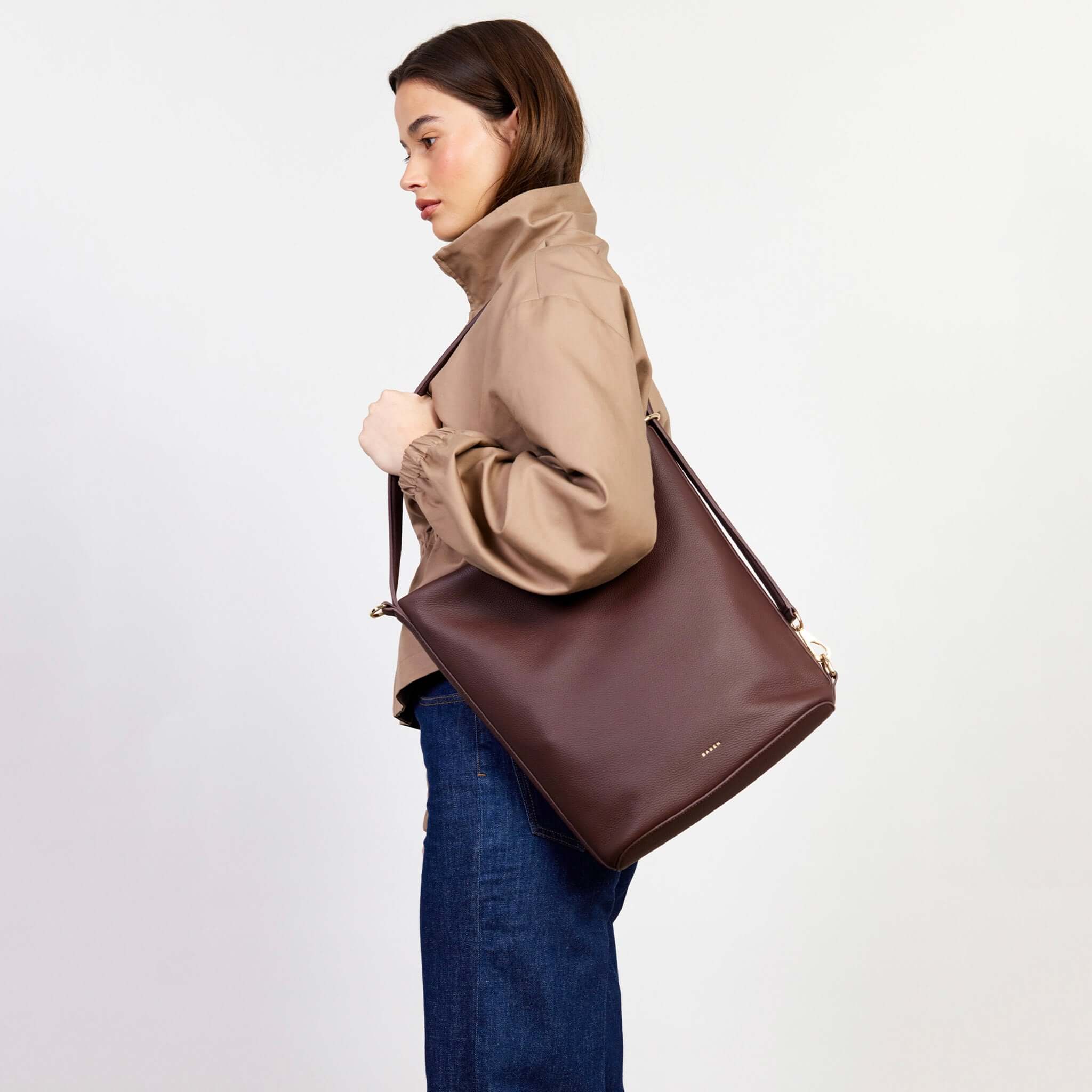 Alt Tag: Saben June Shoulder Bag - Espresso Luxe bucket-style tote with adjustable shoulder strap, shown on model in profile