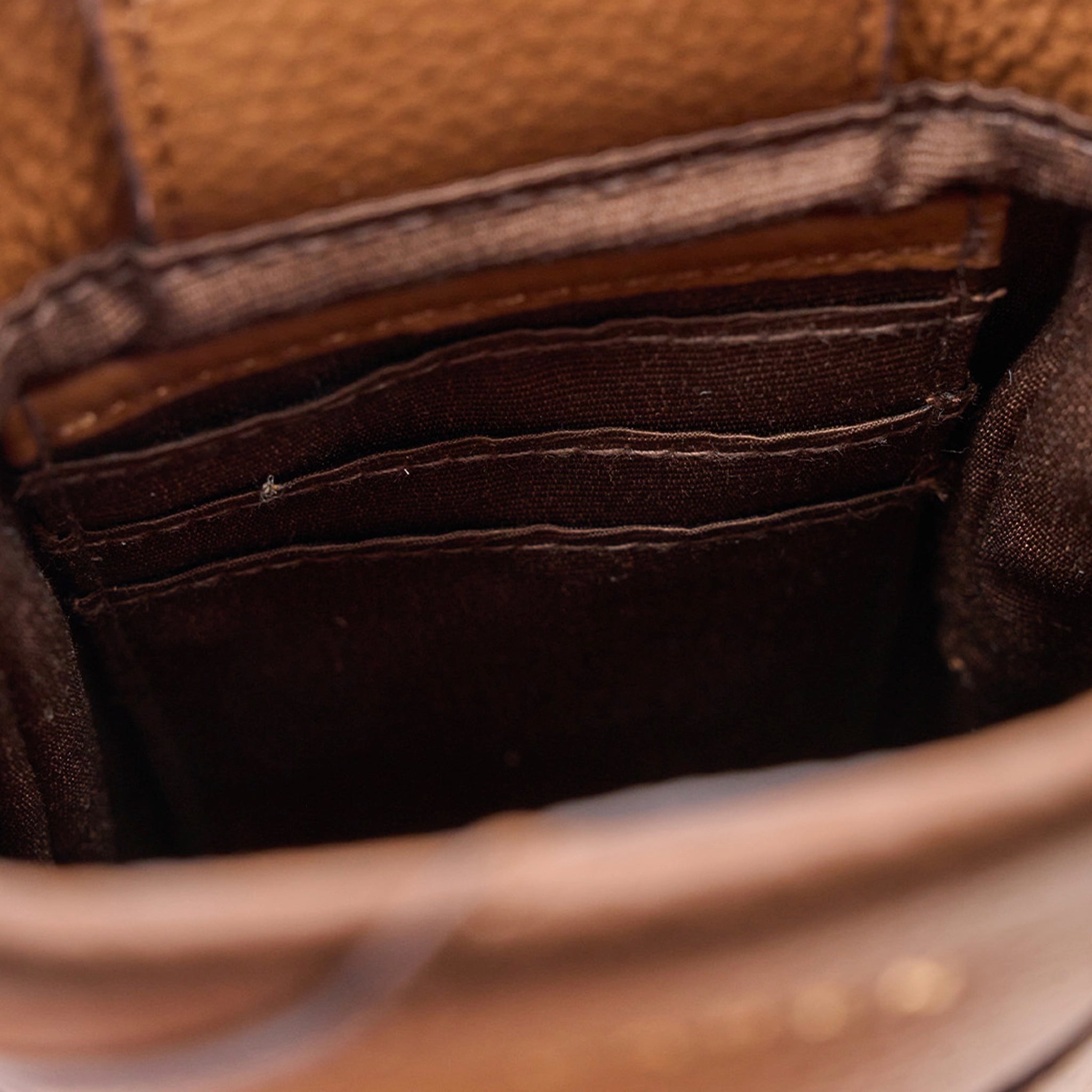 Close-up of a brown leather wallet with visible stitching