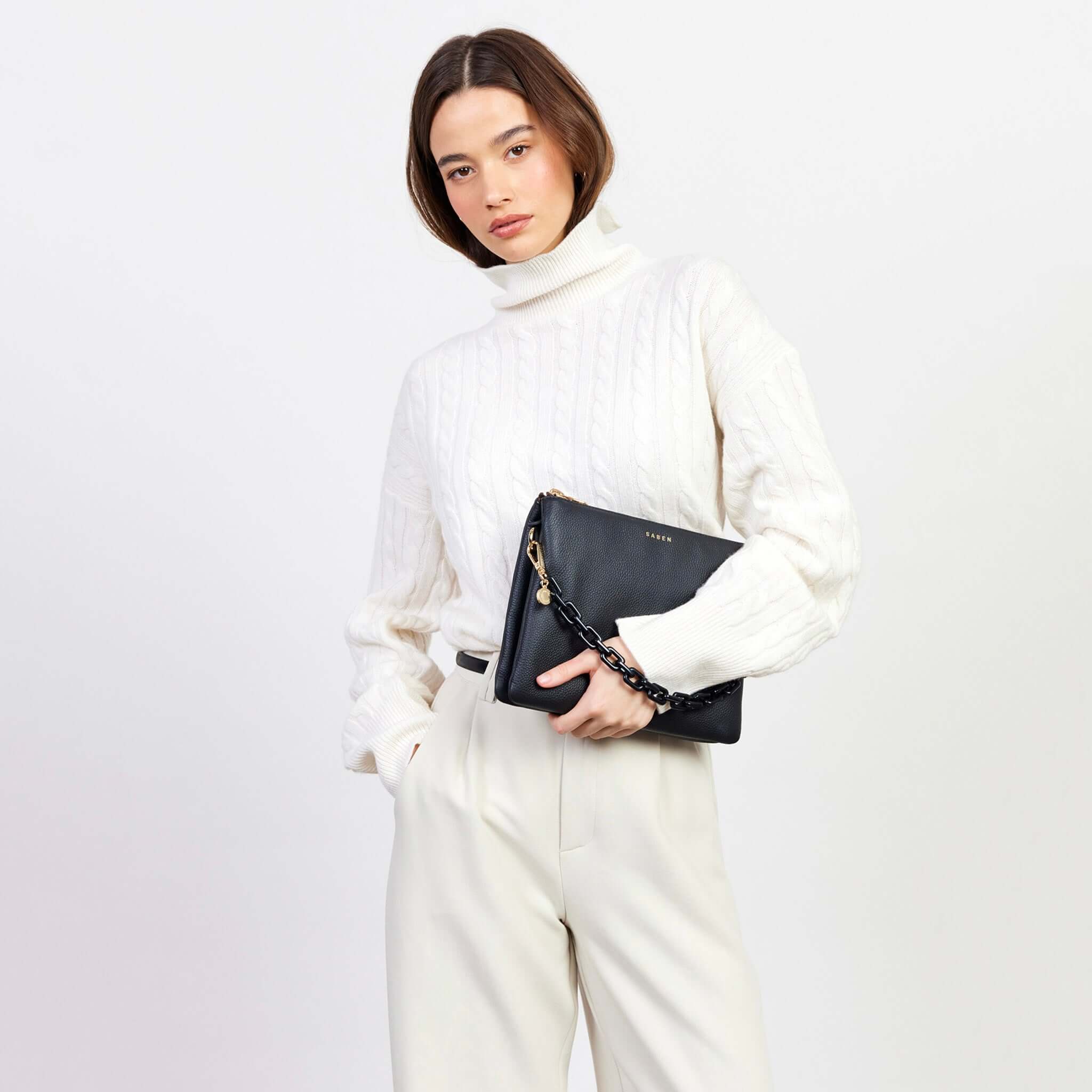 Saben Matilda Crossbody Bag - Black with Tonal Chain held by model, luxe black leather crossbody with tonal chain strap