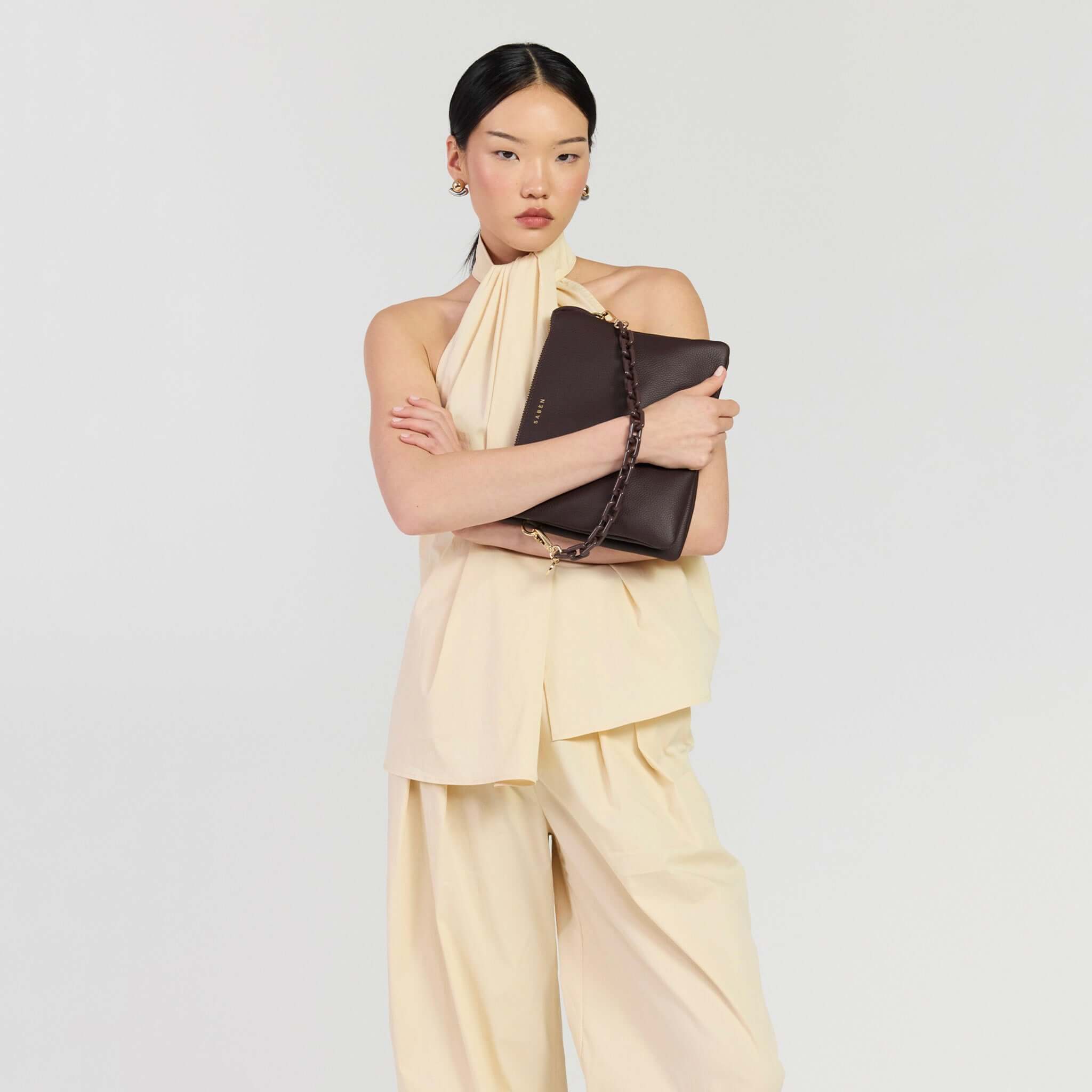 Model showcasing the Saben Matilda Crossbody Bag - Cocao with Tonal Chain in a stylish outfit.