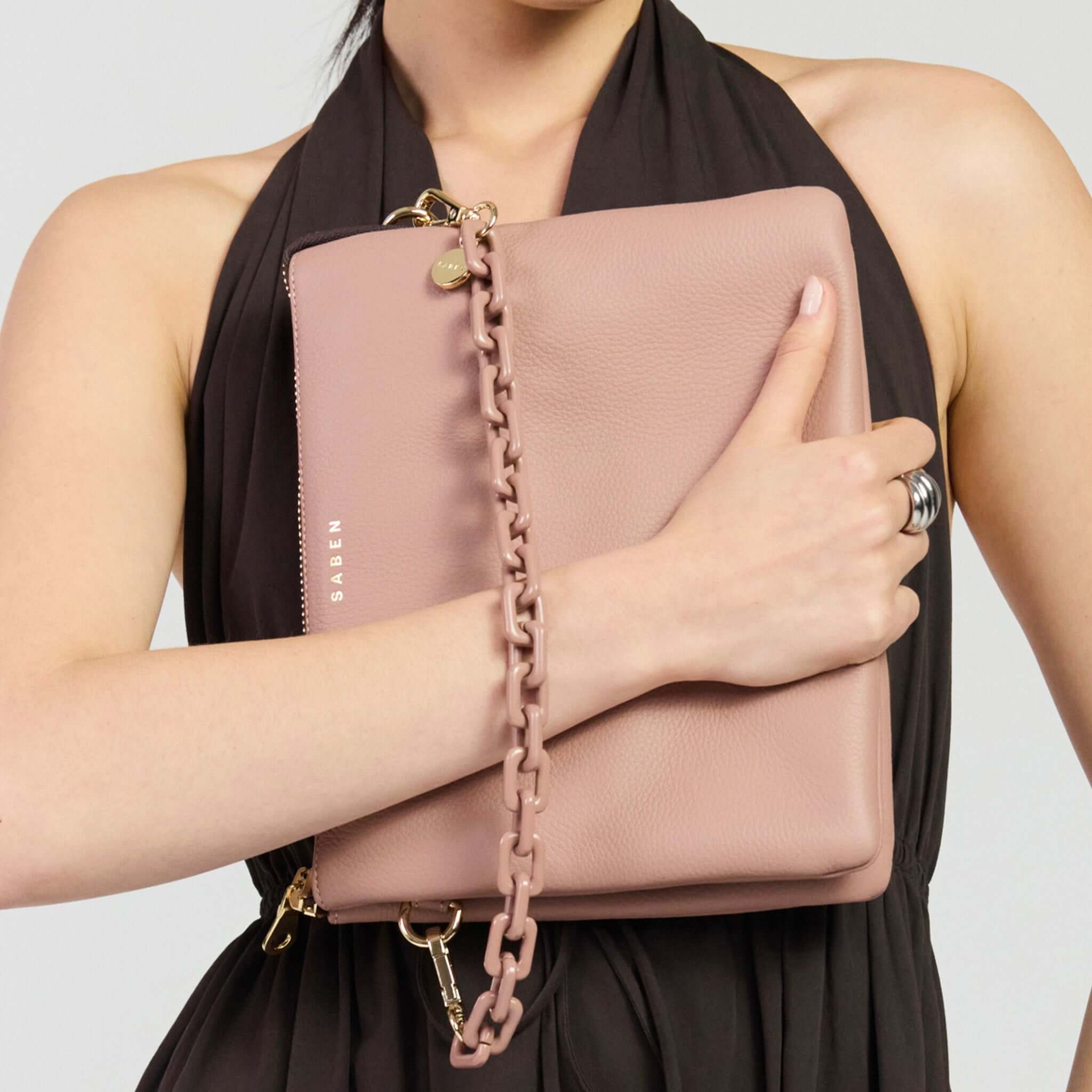 Saben Matilda Crossbody Bag - Rosewater with Tonal Chain held in a woman's hands.