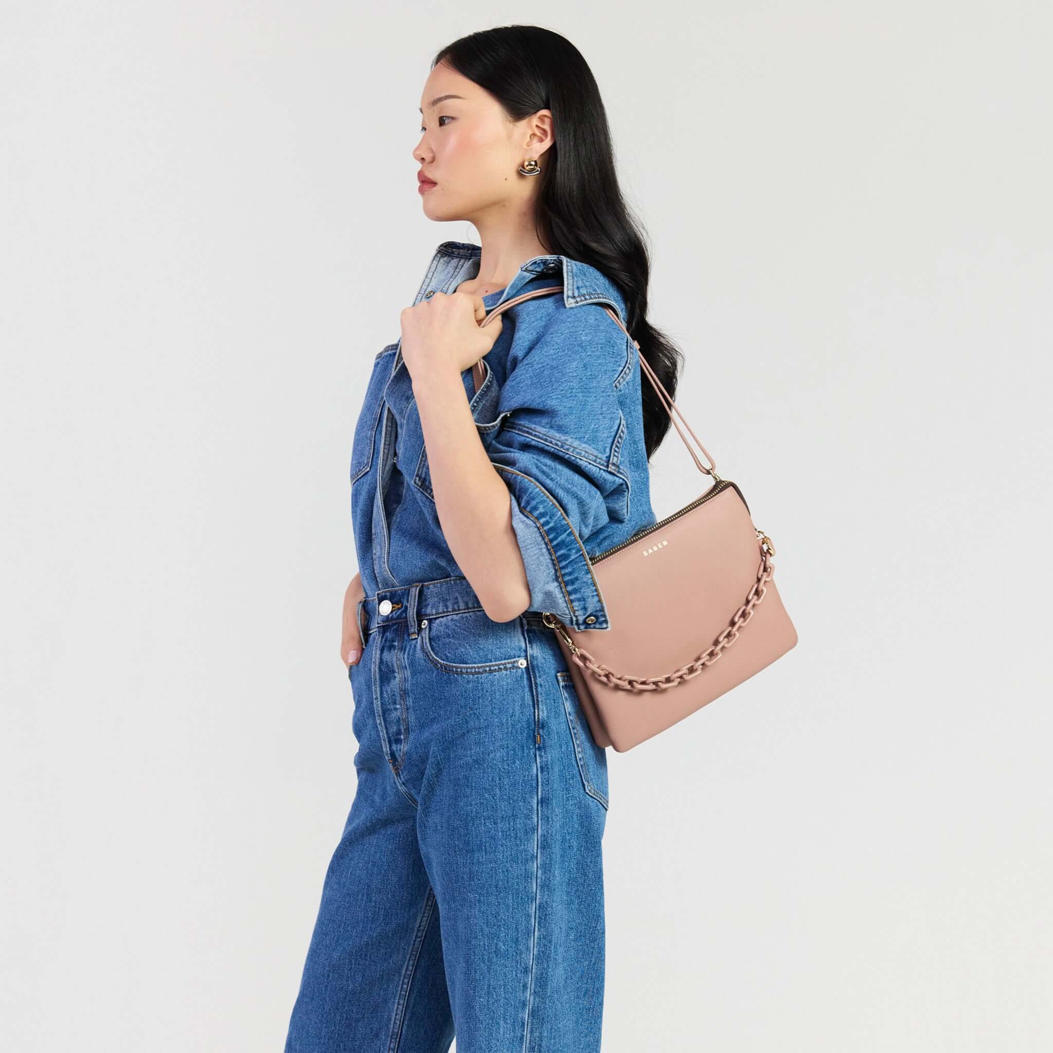 Saben Matilda Crossbody Bag - Rosewater with Tonal Chain displayed by model in denim outfit.