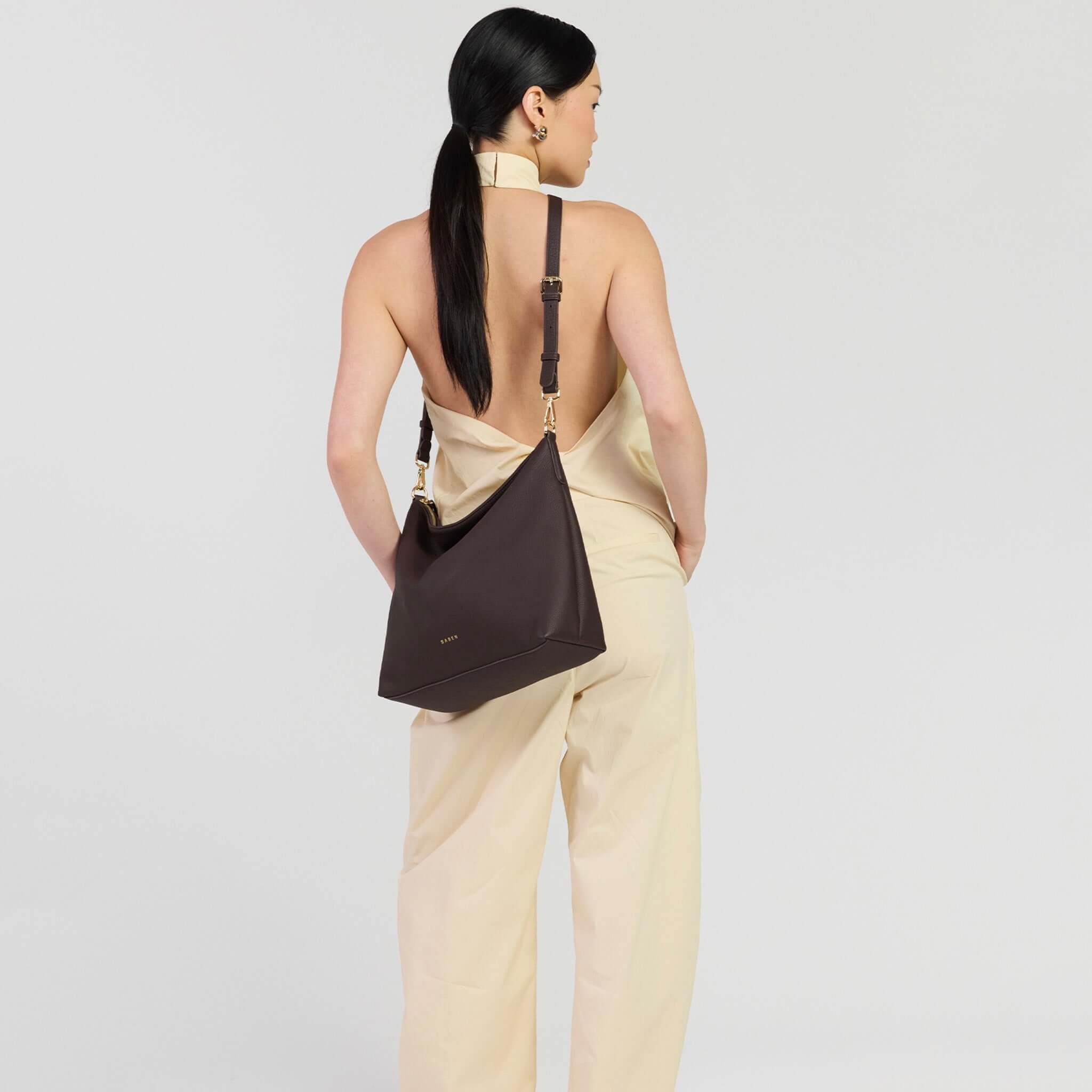 Saben Miki Shoulder Bag - Cacao Luxe worn by a model in a stylish outfit, showcasing its versatile design.