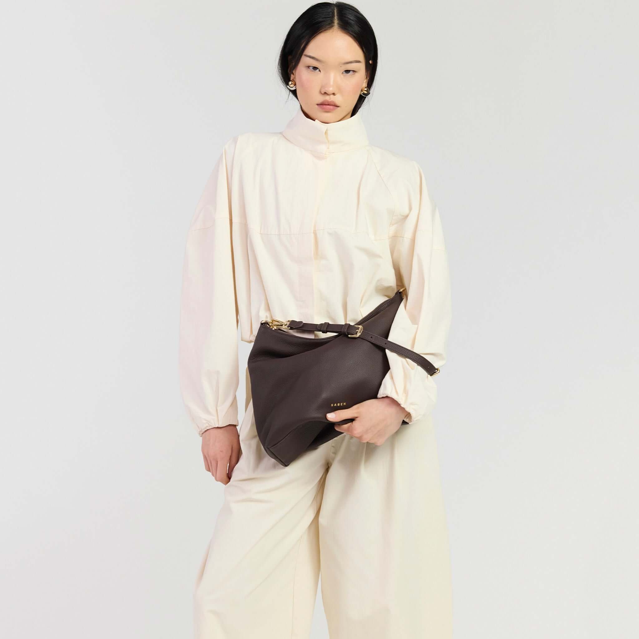 Saben Miki Shoulder Bag - Cacao Luxe worn by model in stylish outfit, showcasing its polished and practical design.