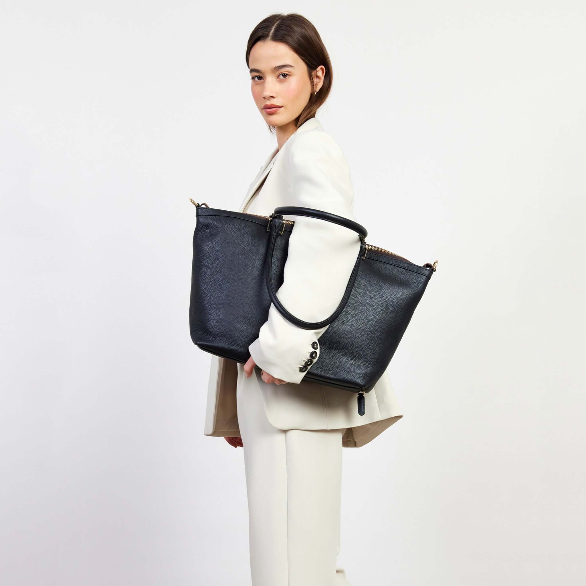 Alt Tag: Saben Milan Carry-All Bag - Black carry-all tote with shoulder straps shown worn by model, spacious everyday work and travel bag