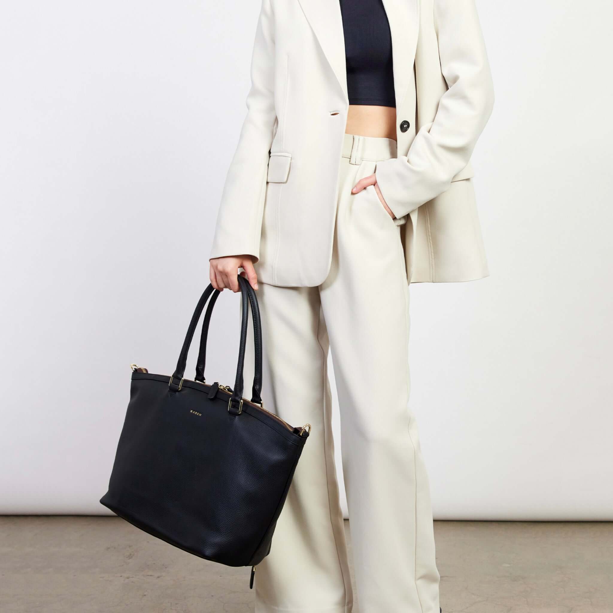 Alt Tag: Saben Milan Carry-All Bag - Black carry-all tote with shoulder straps, styled as work, baby bag or gym laptop hauler