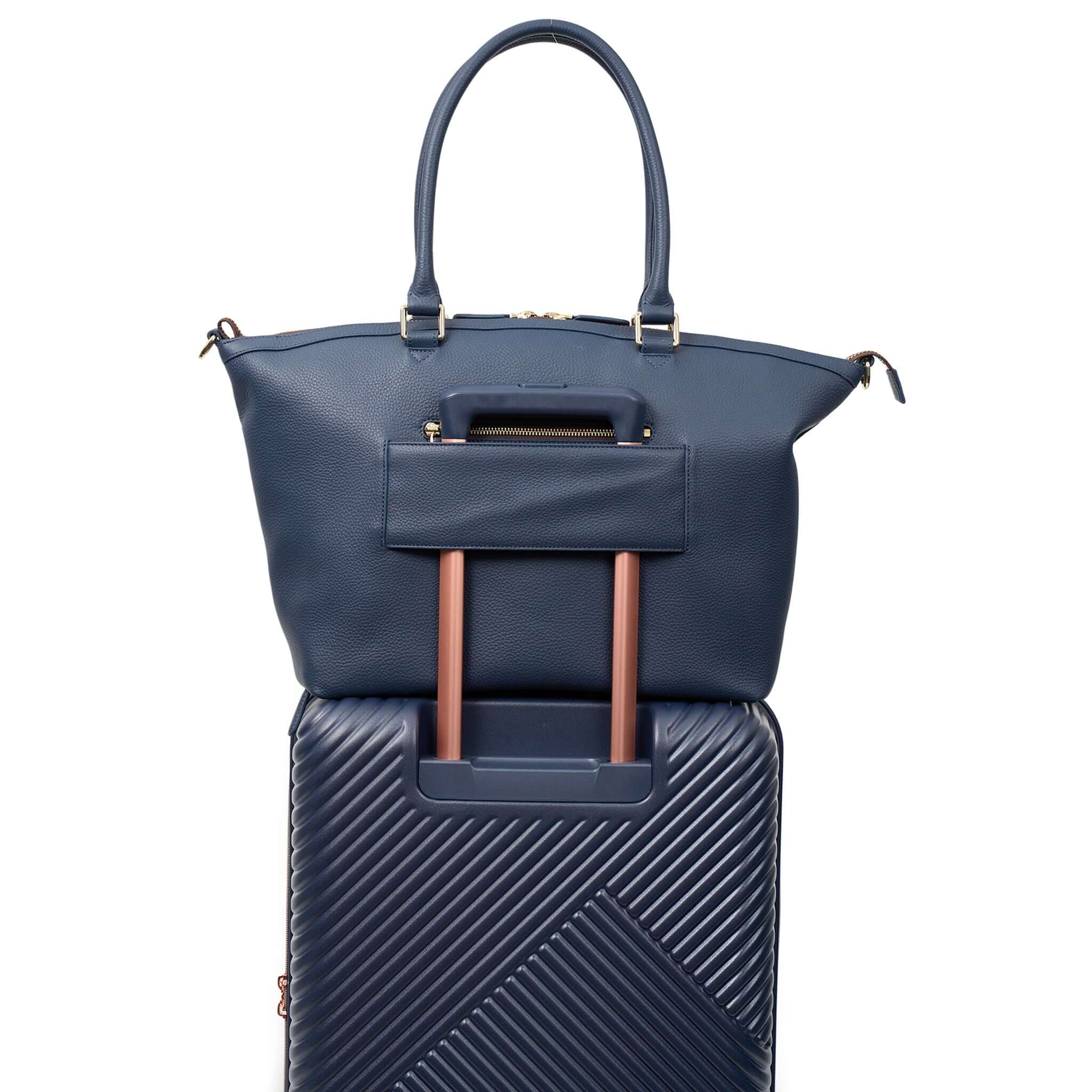 Saben Roma Weekender Carry-All Bag - Ink displayed on a suitcase, showcasing its stylish design and convenient hook.