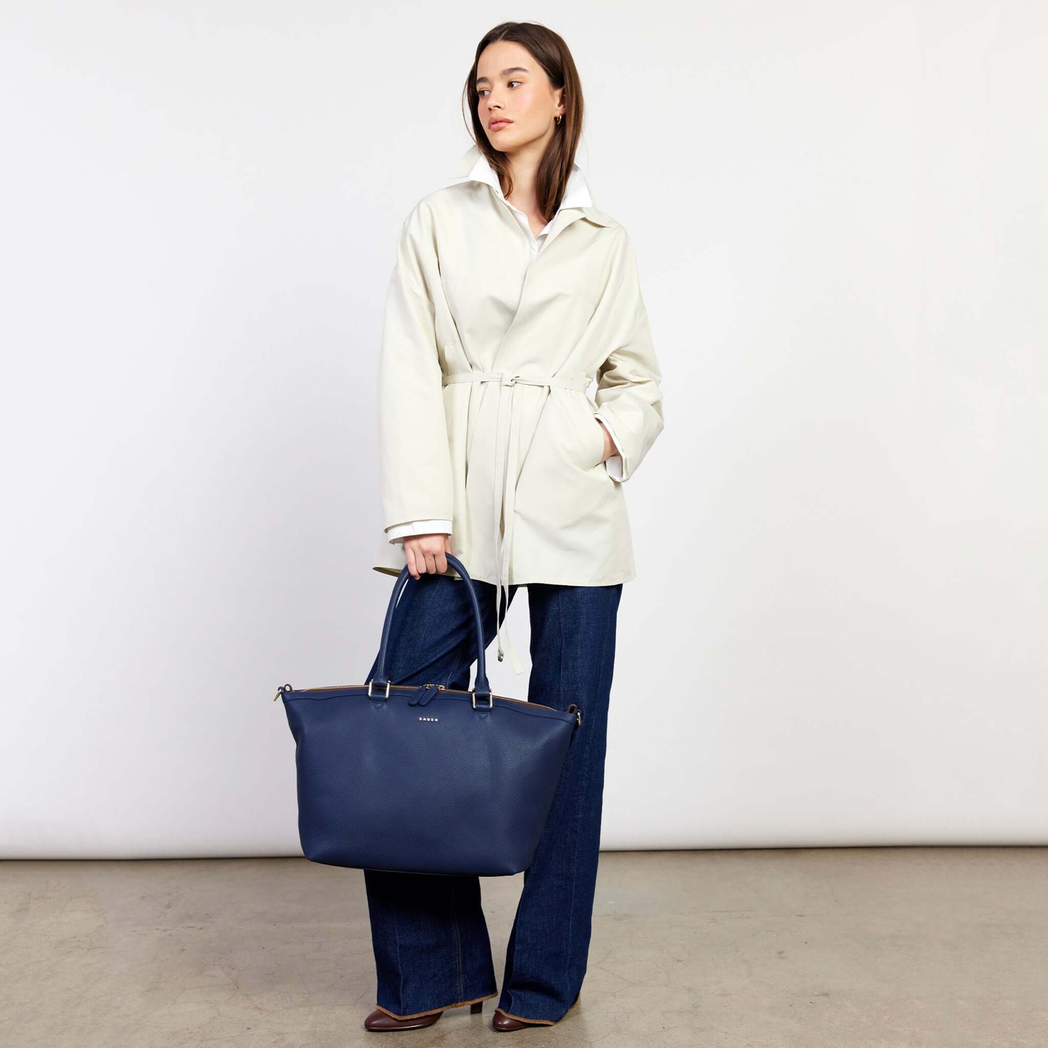 Model showcasing Saben Milan Carry-All Bag - Ink, stylishly paired with a chic outfit, perfect for any occasion.
