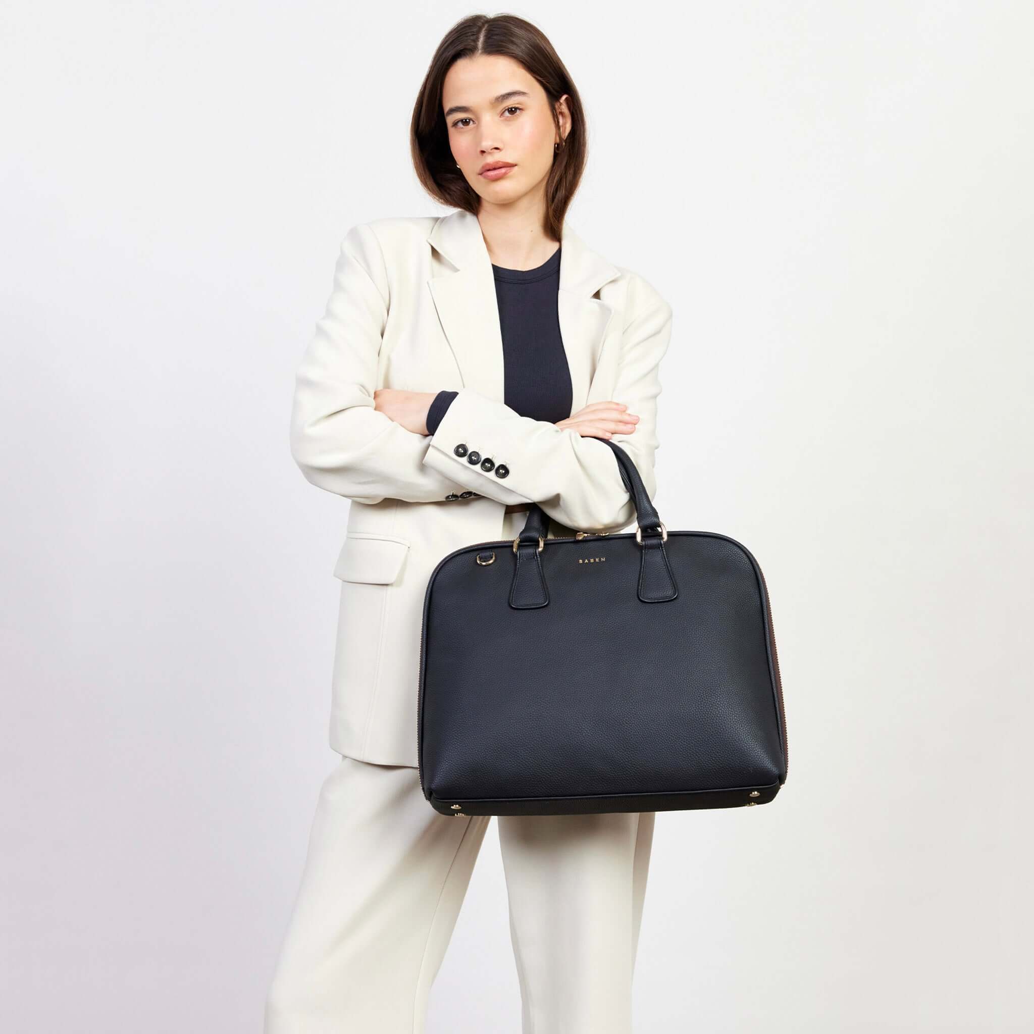 Saben Parker Briefcase - Black carried by model, sleek professional laptop briefcase with top handles for commuting and travel