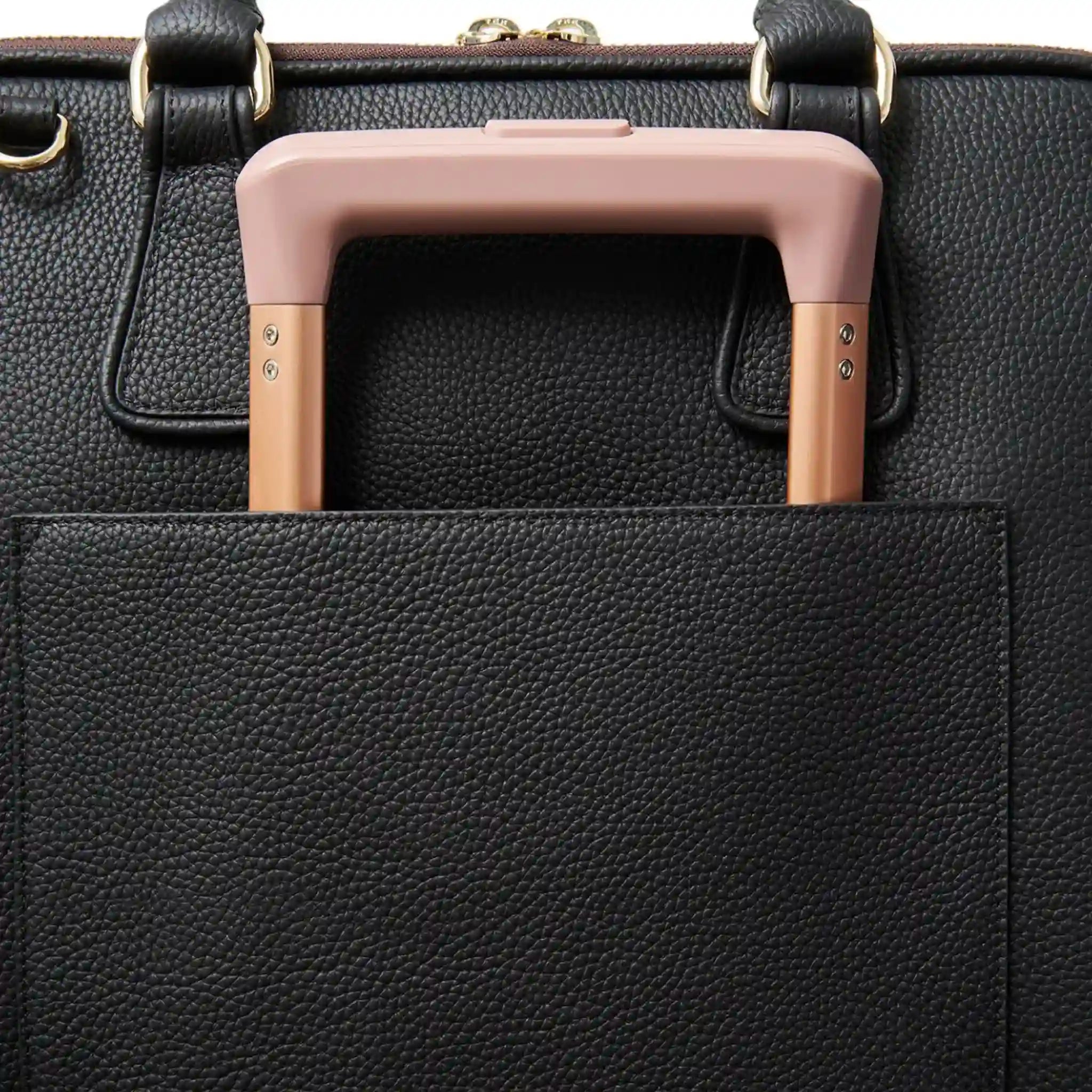 Black leather handbag with a pink handle