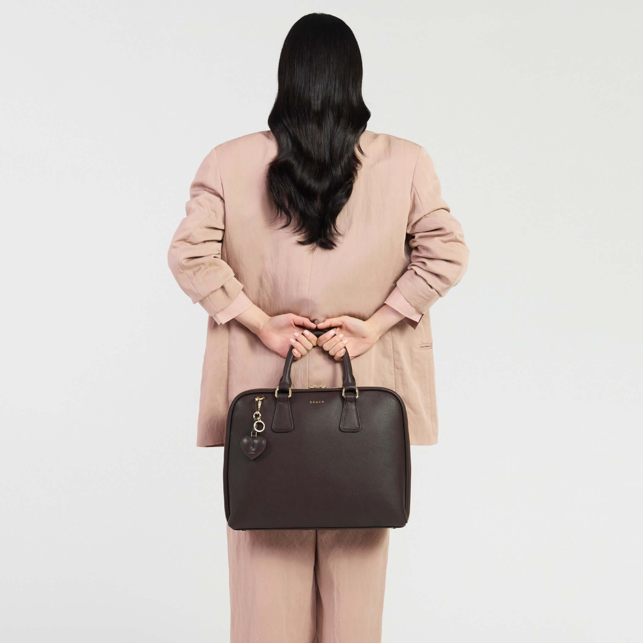 Saben Parker Briefcase - Cacao showcased by a model in a stylish outfit holding it.