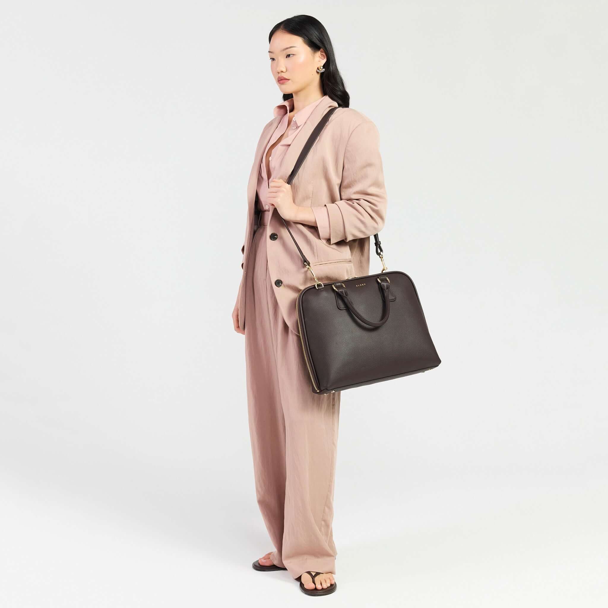 Saben Parker Briefcase - Cacao featured on a model in professional attire, showcasing its stylish design and functionality.