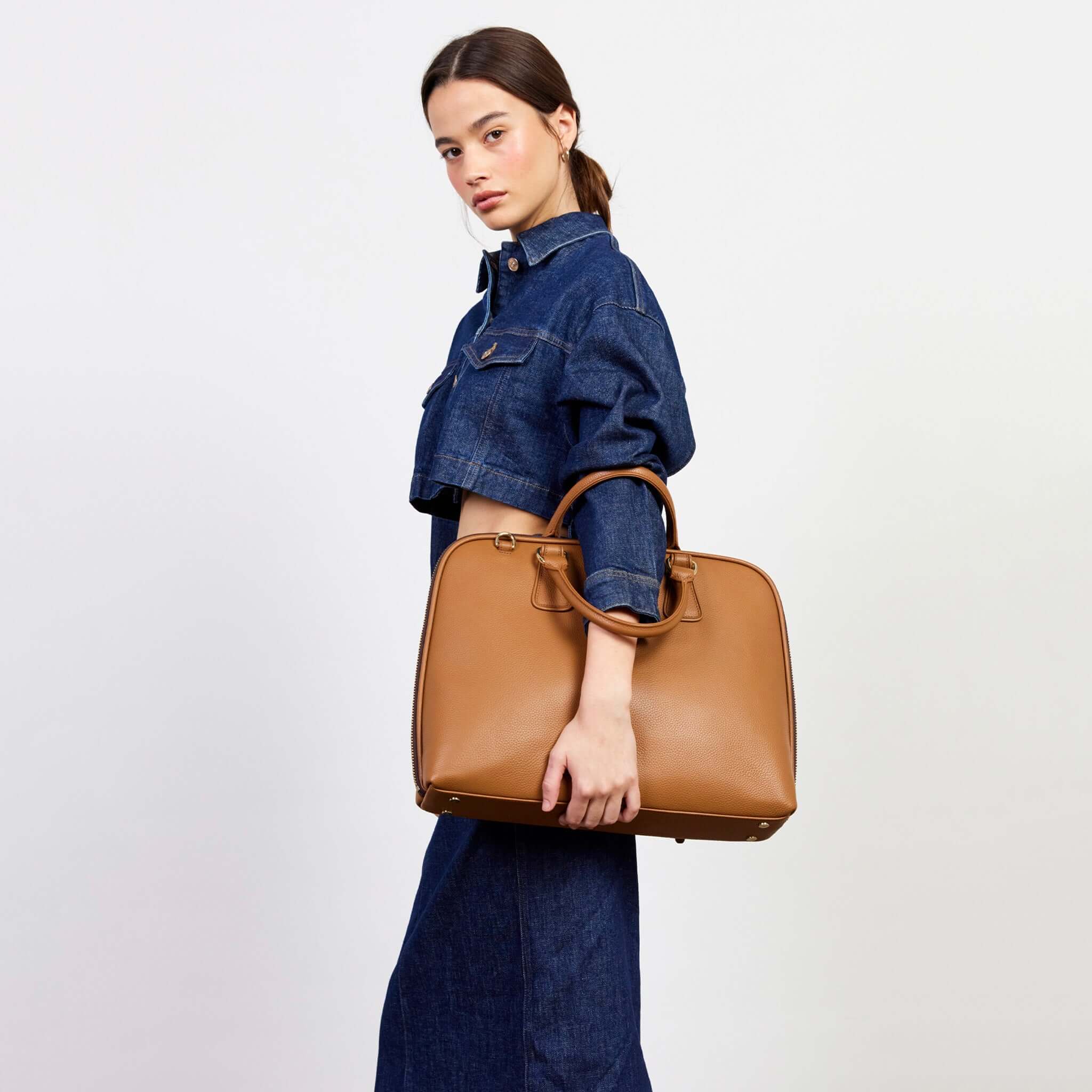 Alt Tag: Saben Parker Briefcase - Toffee premium toffee leather laptop briefcase with top handles, carried by model for work and travel