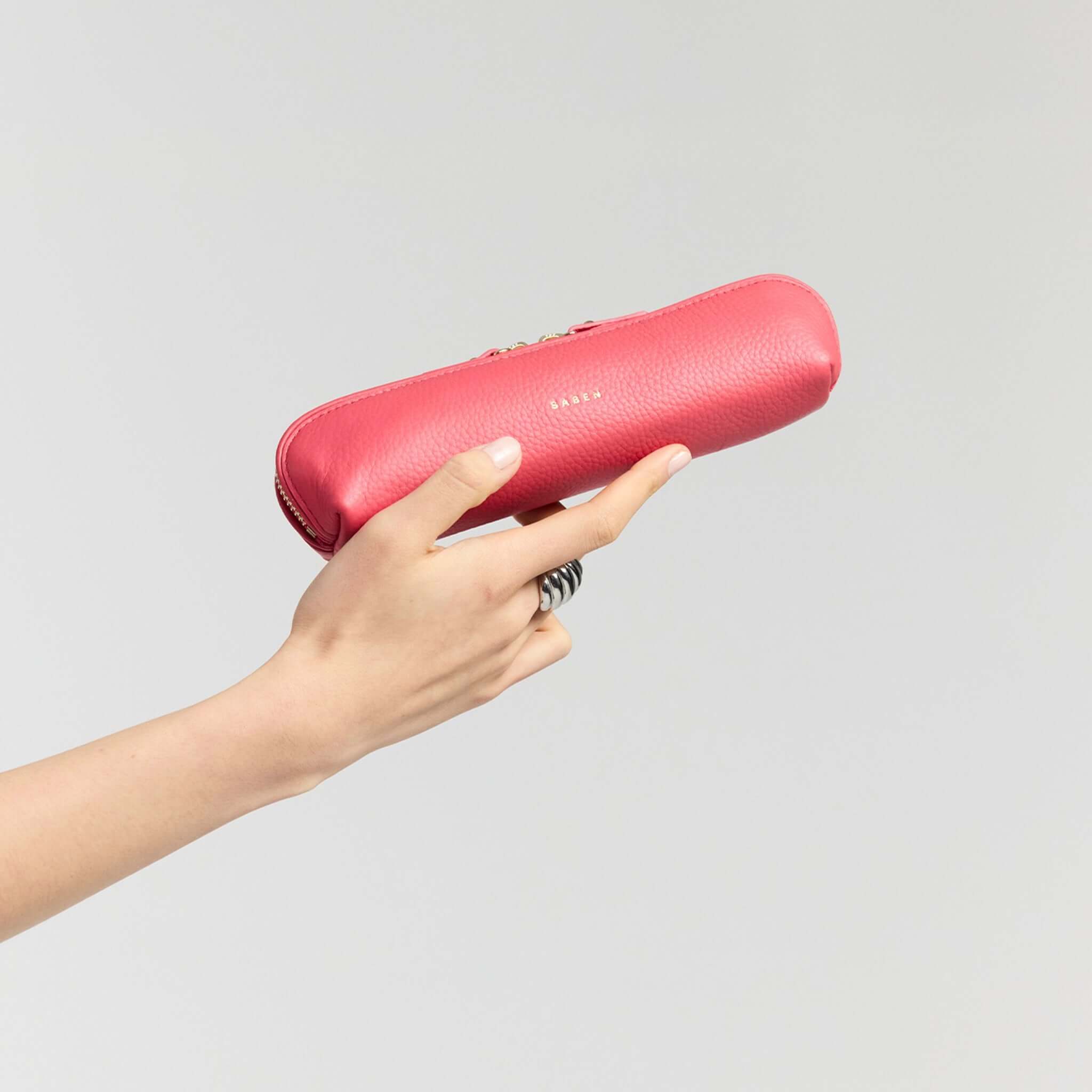 Saben Tali Pencil / Cosmetic Case - Azalea held in hand, showcasing its chic design and vibrant color.