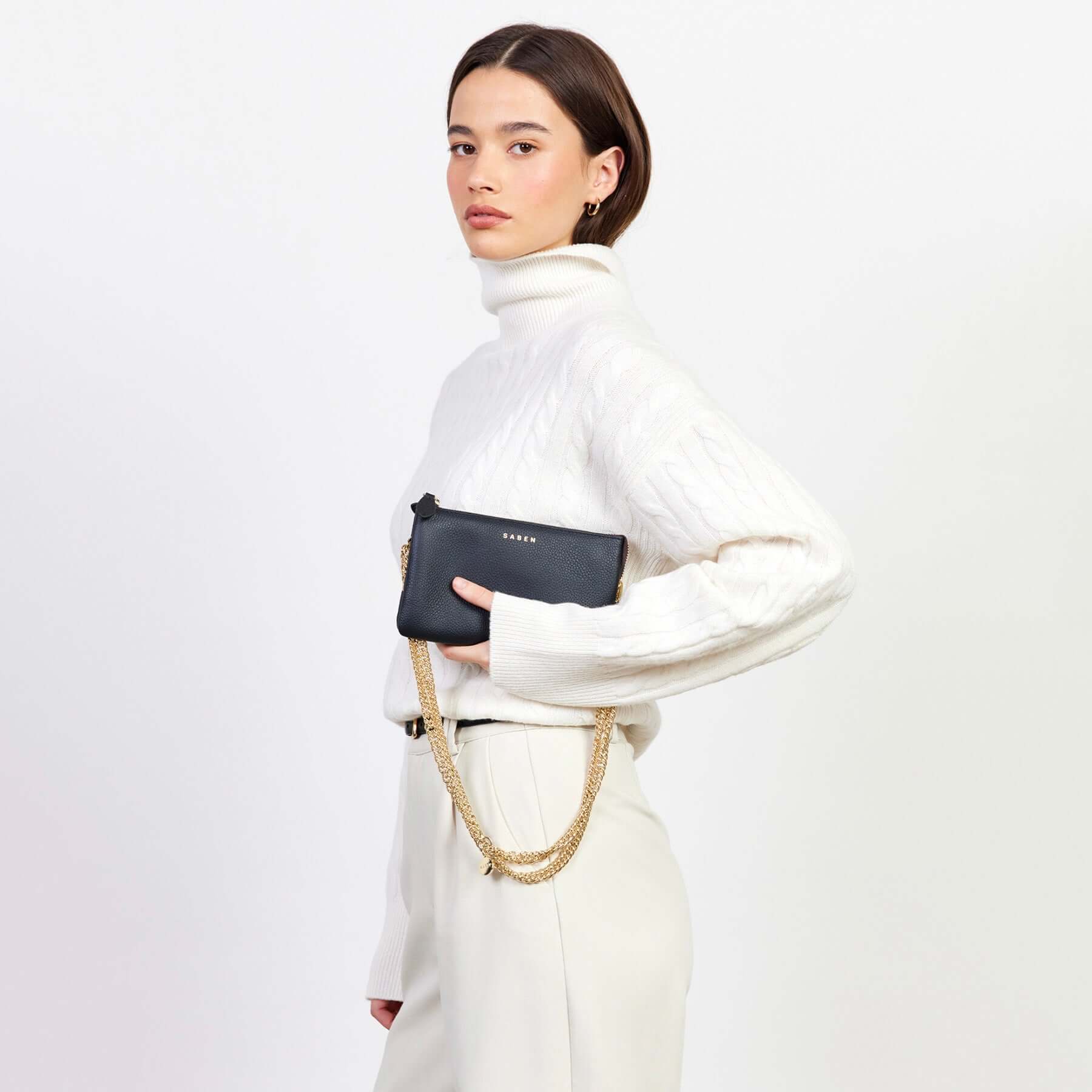 Alt Tag: Saben Tilly Crossbody Bag - Black black leather wallet clutch crossbody with gold chain strap worn on model