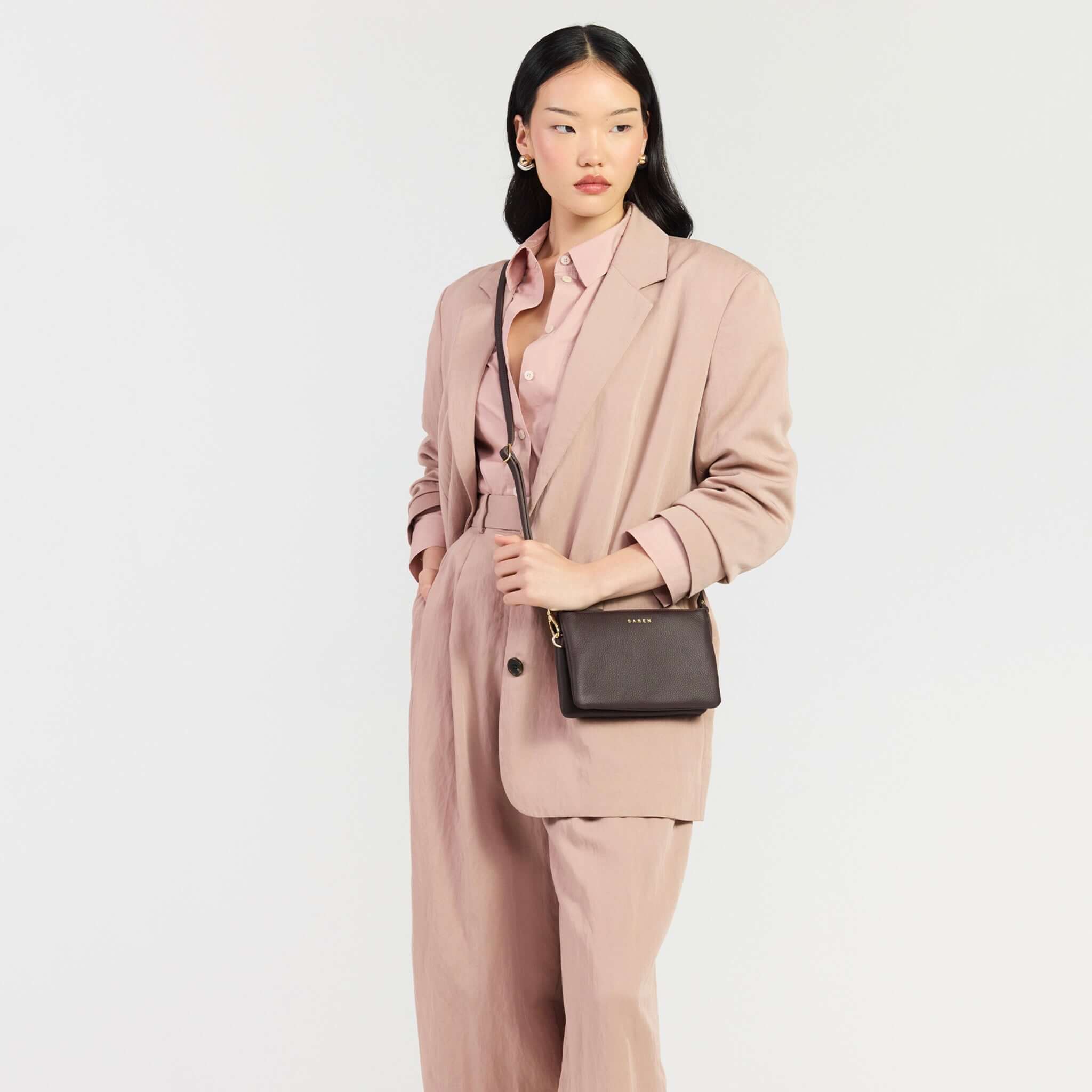 Saben Tilly Crossbody Bag - Cacao worn by a model in a stylish outfit.