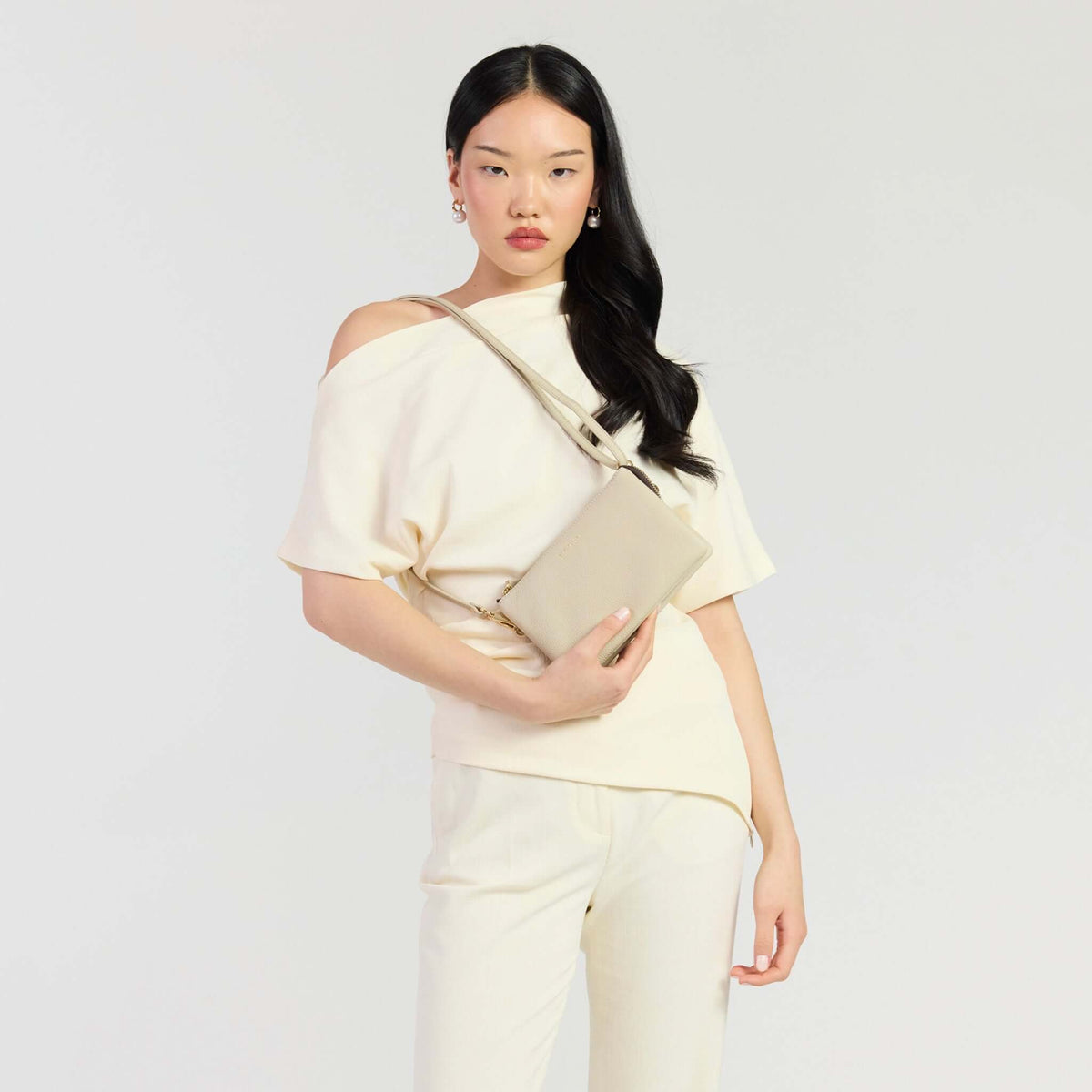 Saben Tilly Crossbody Bag - Oyster worn by a model in a stylish outfit.