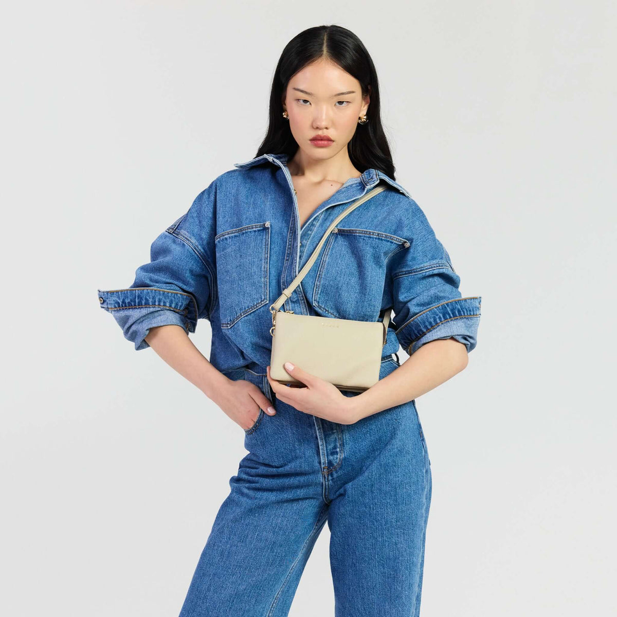 Saben Tilly Crossbody Bag - Oyster styled by a model in denim attire.
