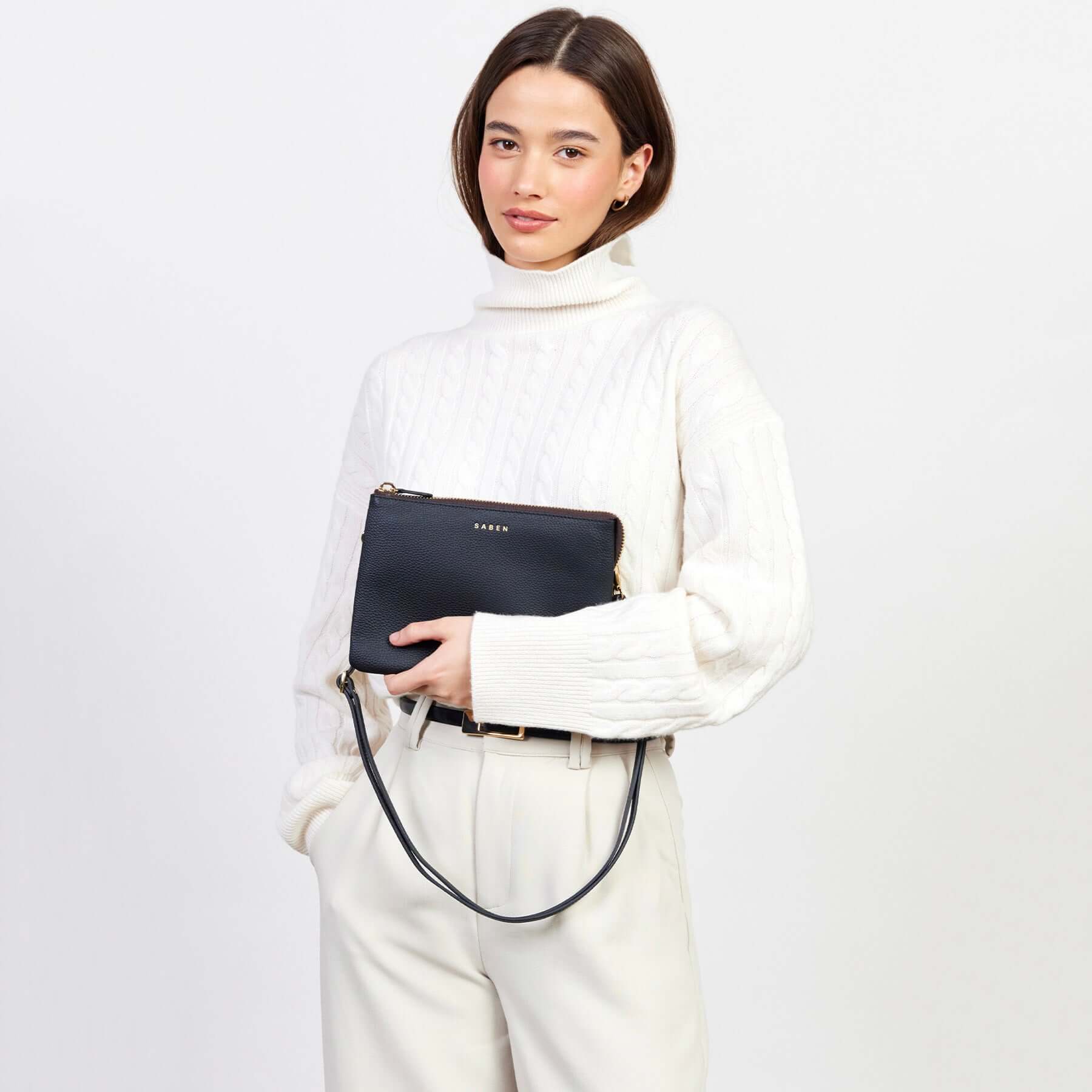 Alt Tag: Saben Tilly's Big Sis Crossbody Bag - Black pebbled leather crossbody clutch with strap, styled on model