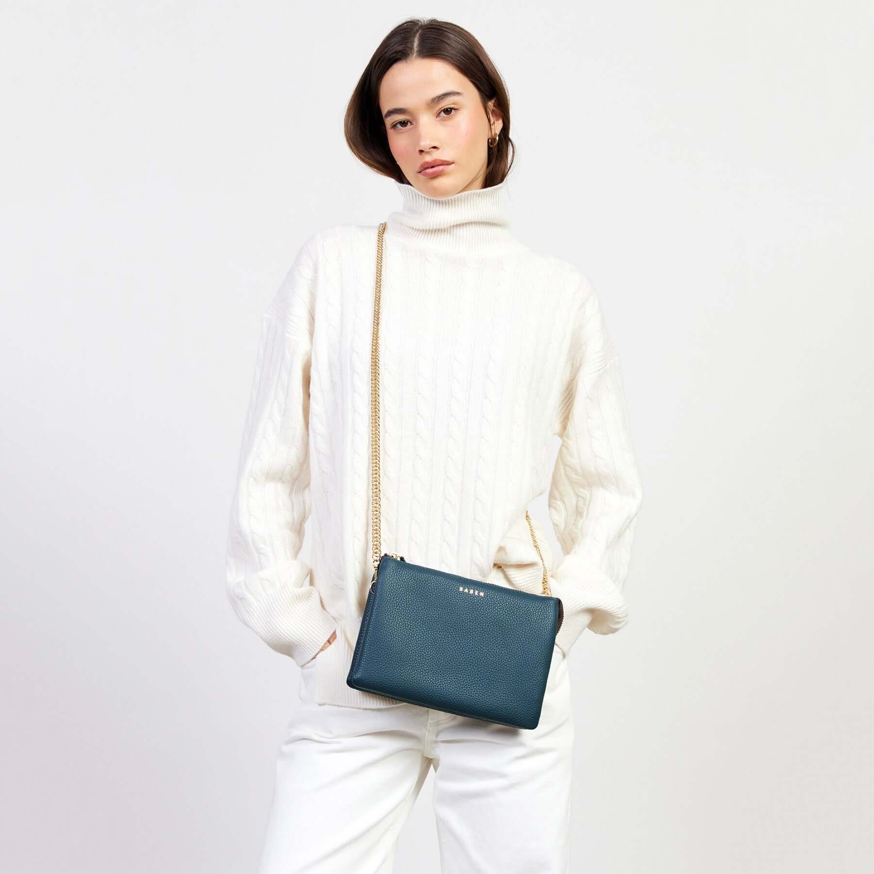 Alt Tag: Model wearing Saben Tilly's Big Sis Crossbody Bag - Hunter Green pebbled leather crossbody with gold chain strap