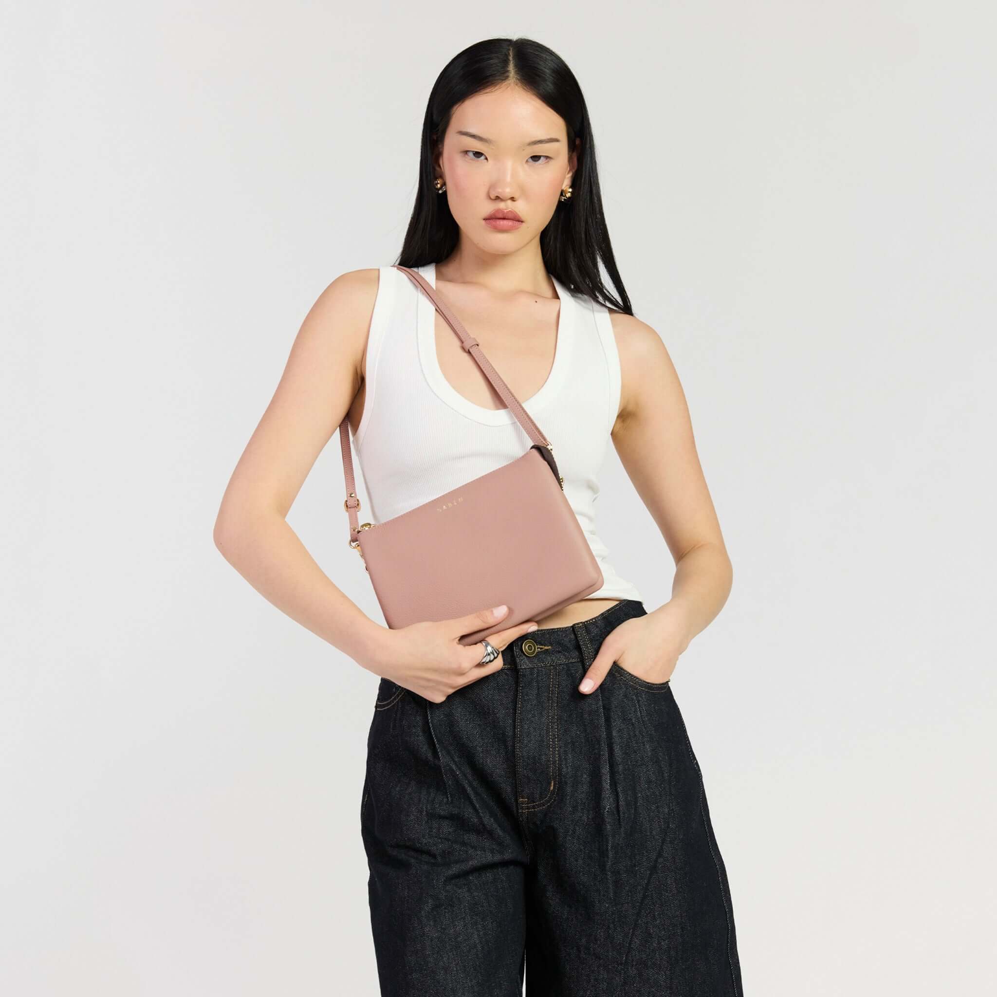 Saben Tilly's Big Sis Crossbody Bag - Rosewater model wearing casual outfit and holding bag.