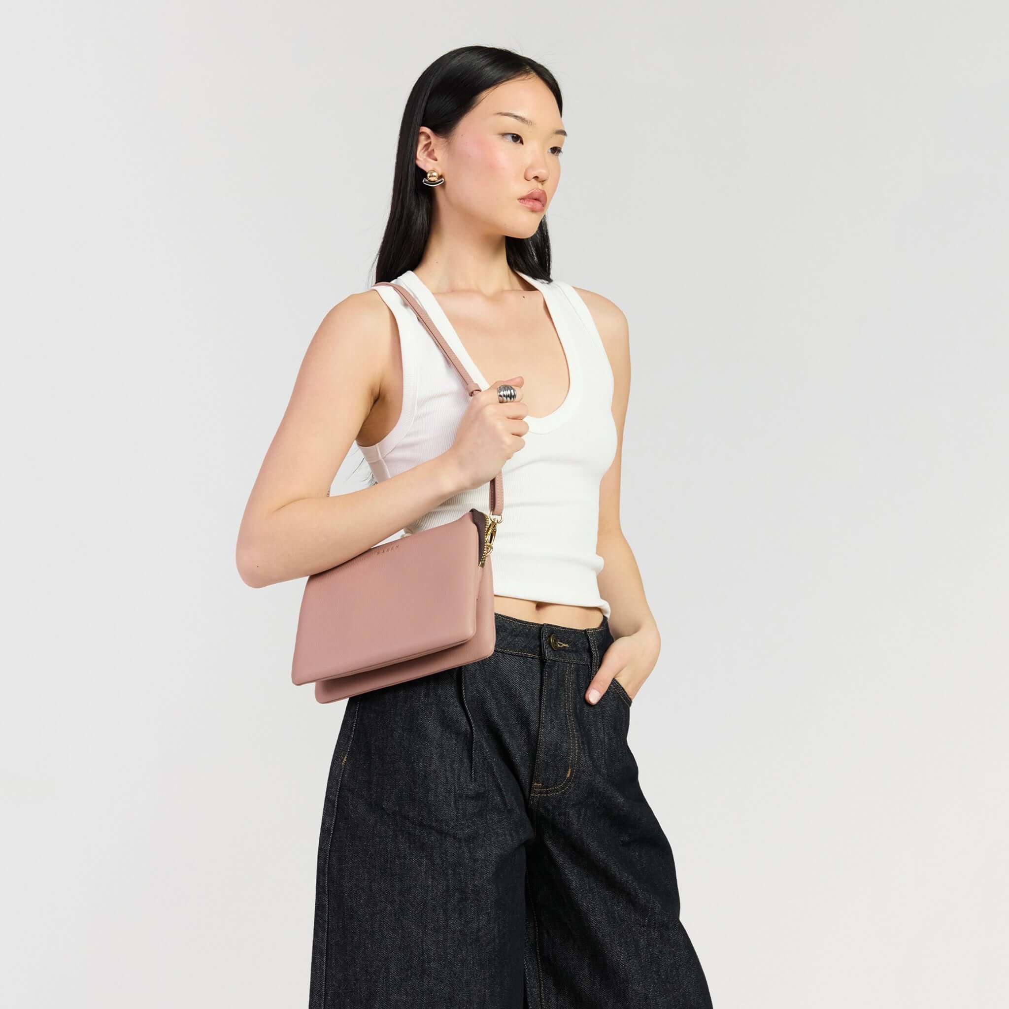 Saben Tilly's Big Sis Crossbody Bag - Rosewater worn by a model in casual attire.