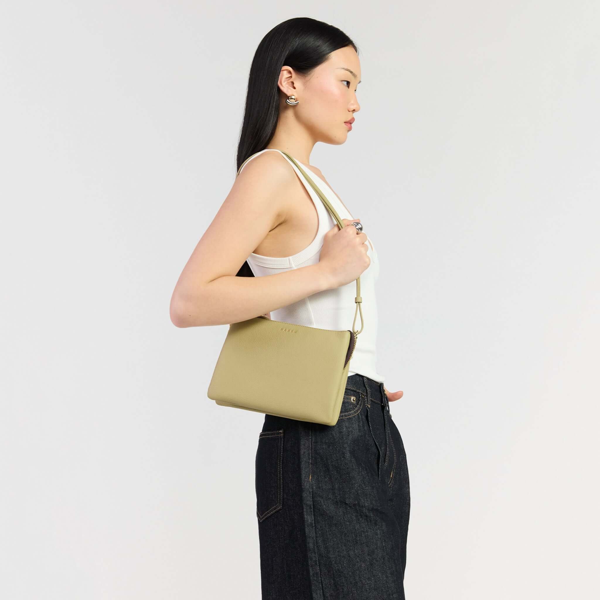 Saben Tilly's Big Sis Crossbody Bag - Willow being held by a model in a stylish outfit.
