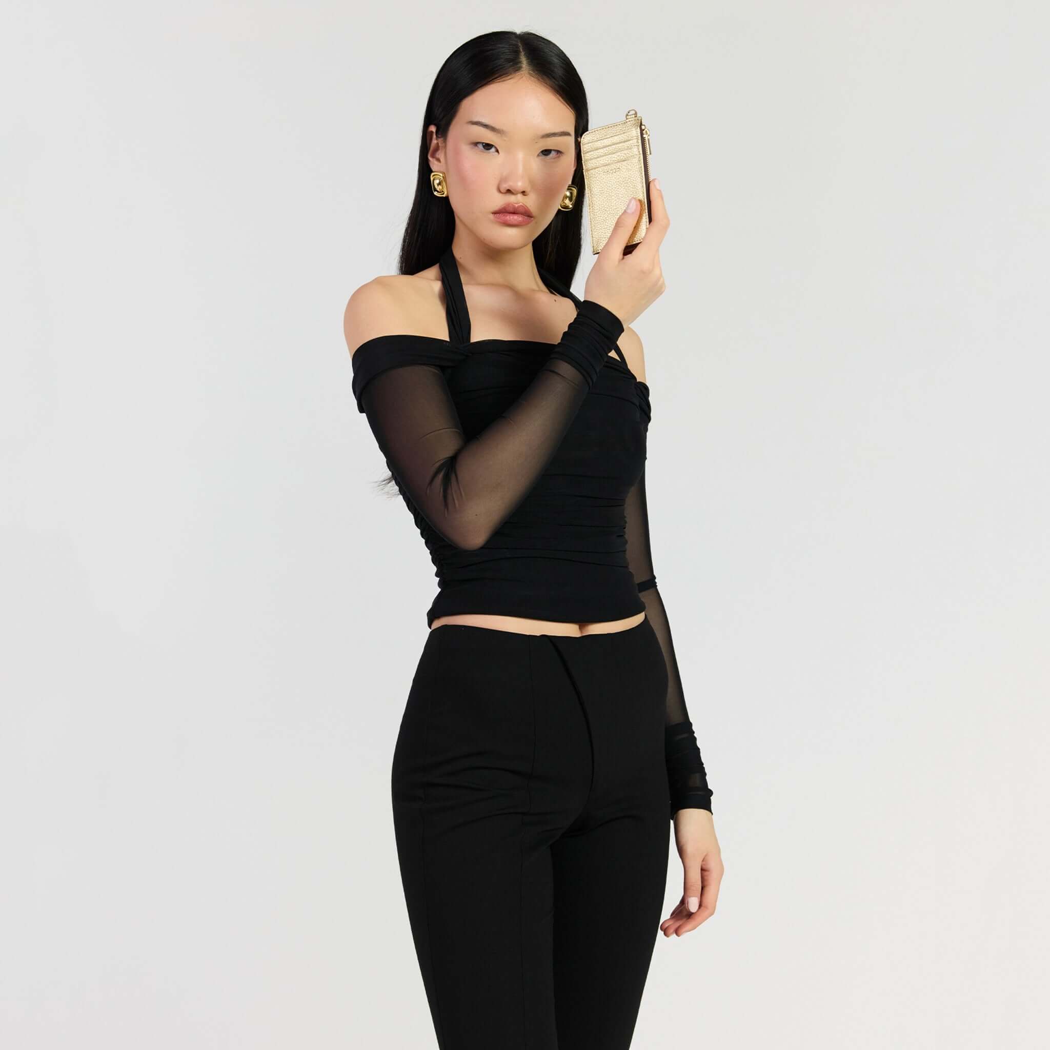 Model showcasing the Saben Winona Card Holder - Champagne Metallic in a stylish outfit.