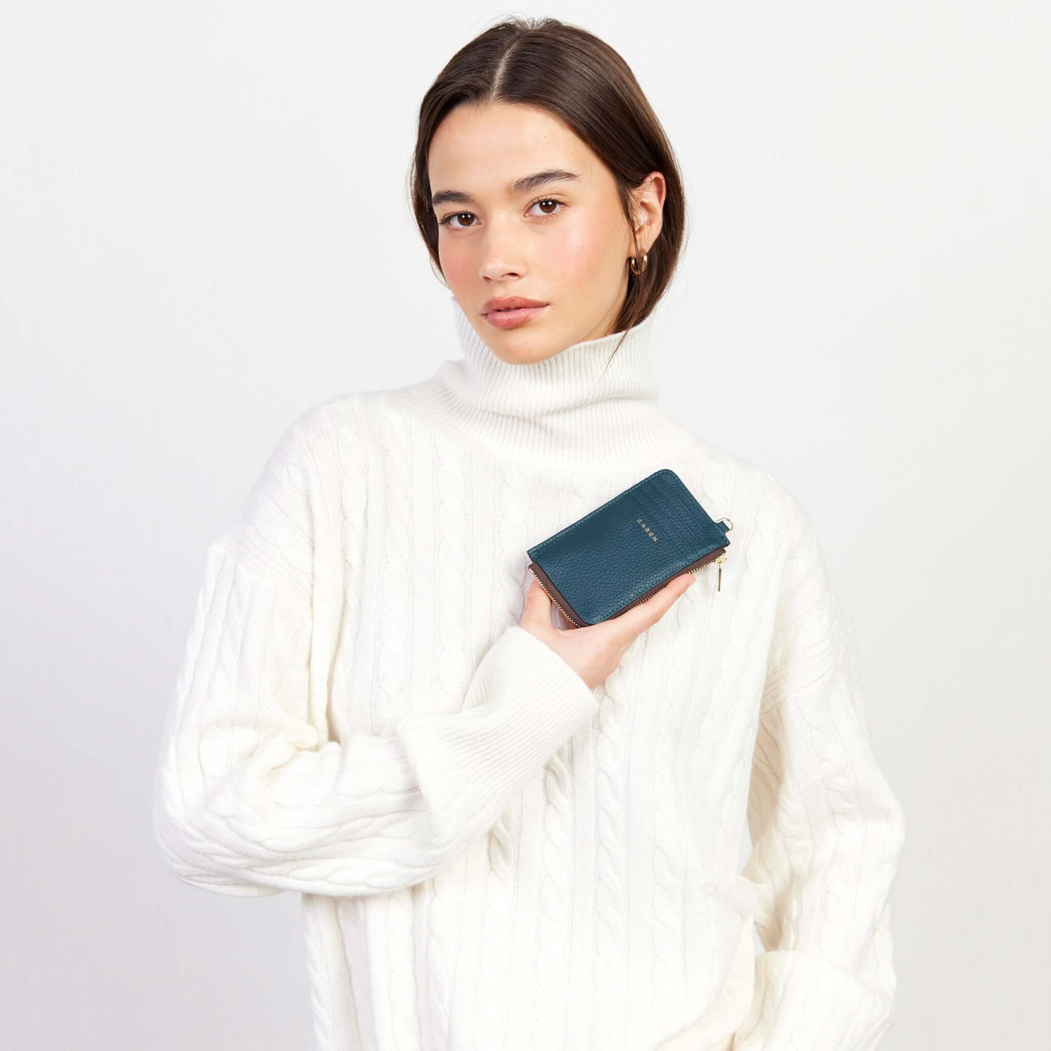 Alt Tag: Saben Winona Card Holder - Hunter Green held by model, textured leather card wallet with zip coin compartment