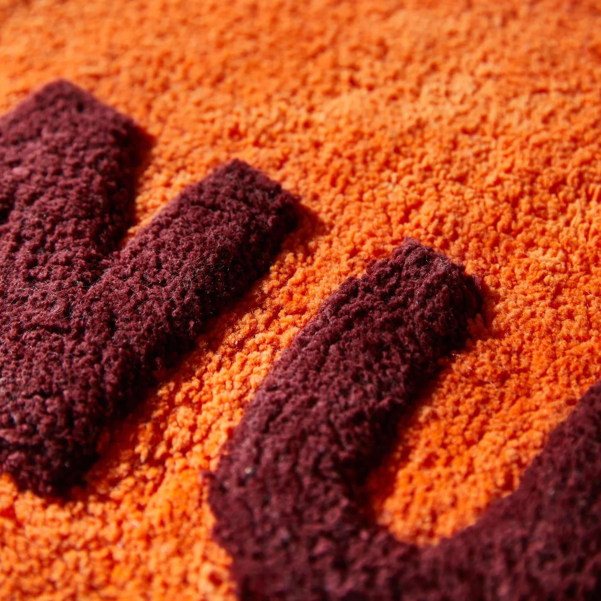 Sage x Clare Amalie Nudie Bath Mat - Orangerie close-up of textured fabric detail in vibrant orange and purple.