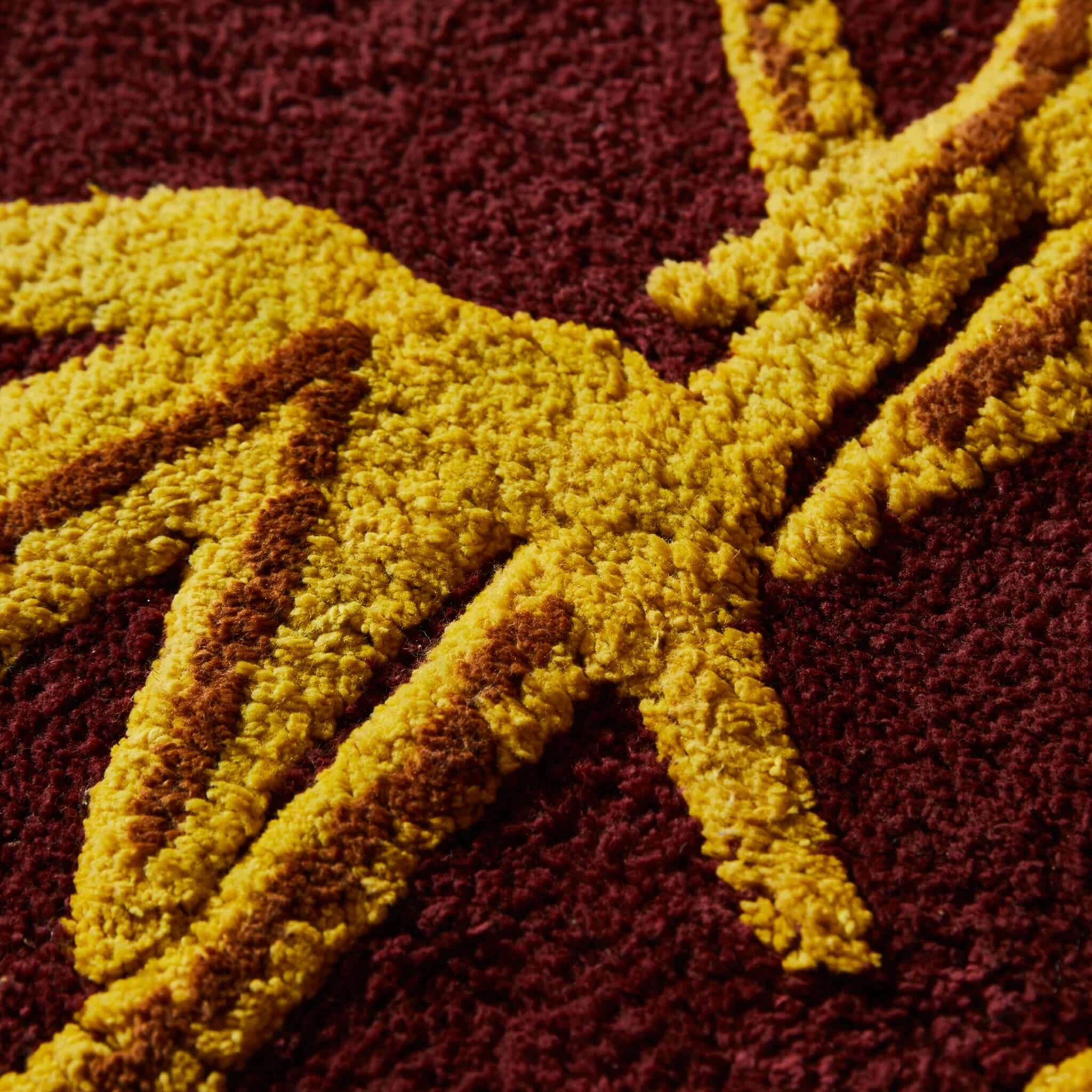 Close-up view of the Sage x Clare Aneta Bath Runner featuring vibrant golden yellow and deep burgundy colors.
