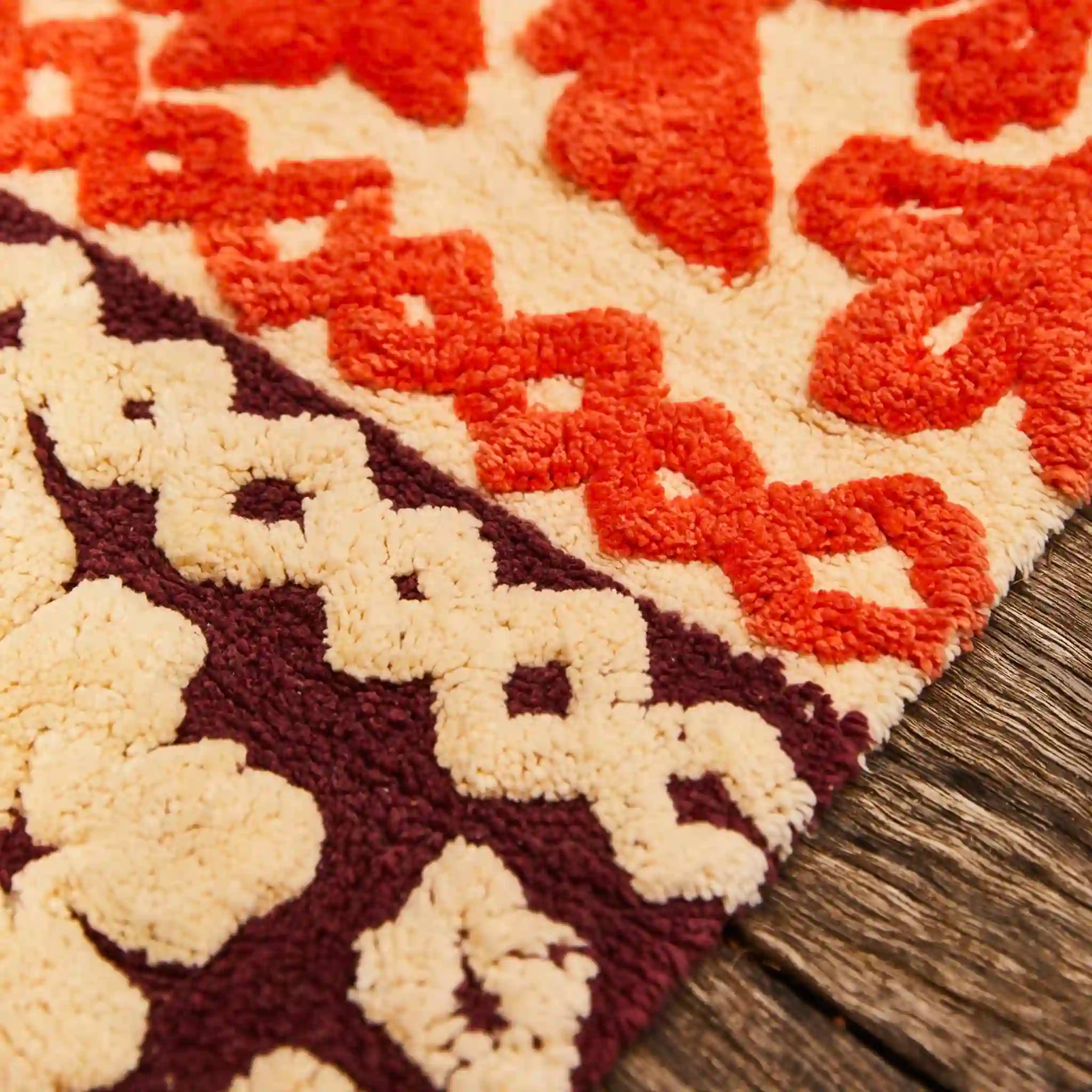Close-up of a textured bath mat with geometric pattern on wooden floor