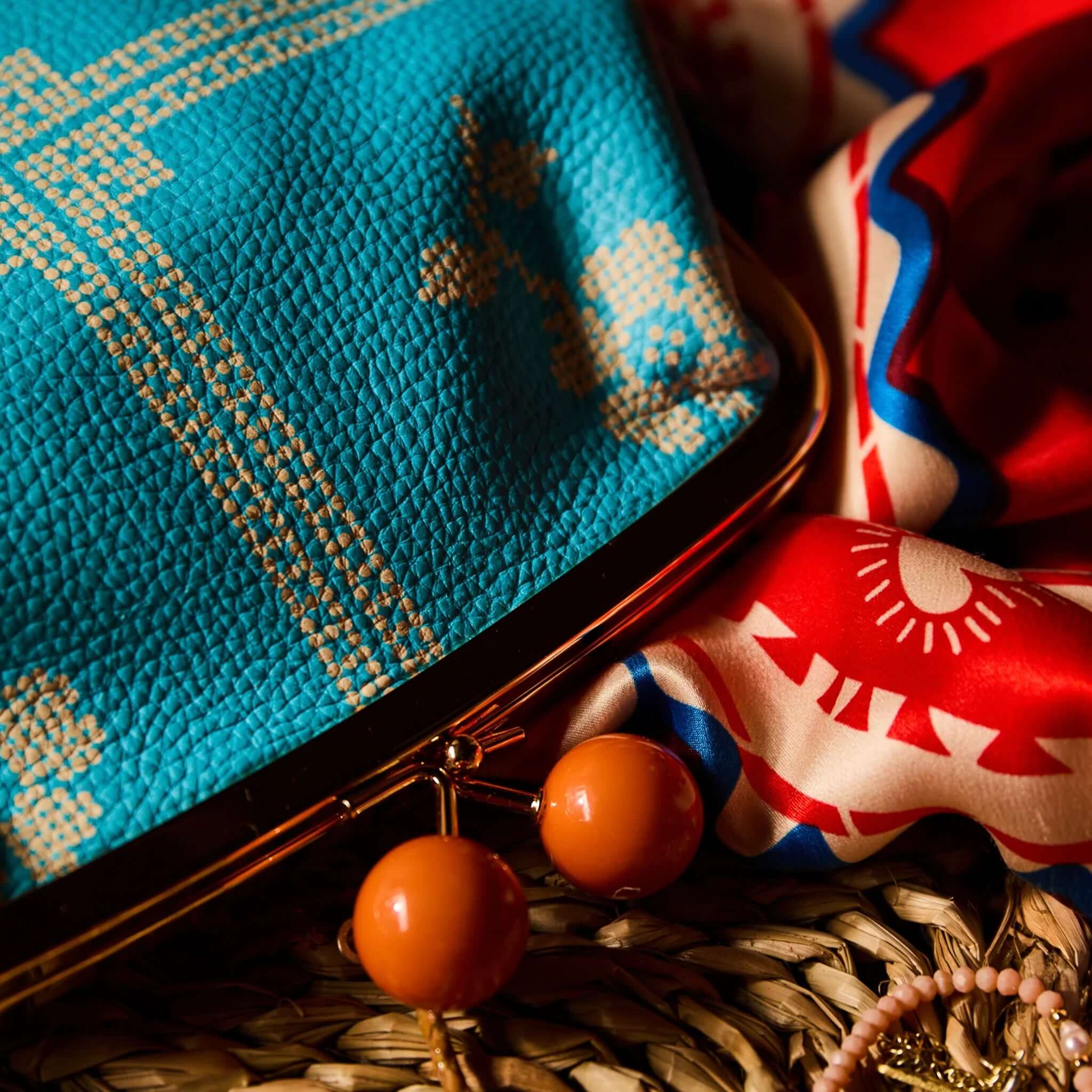 Sage x Clare Bonny Large Purse - Turquoise featuring cream print and coral clasp on a vibrant background.