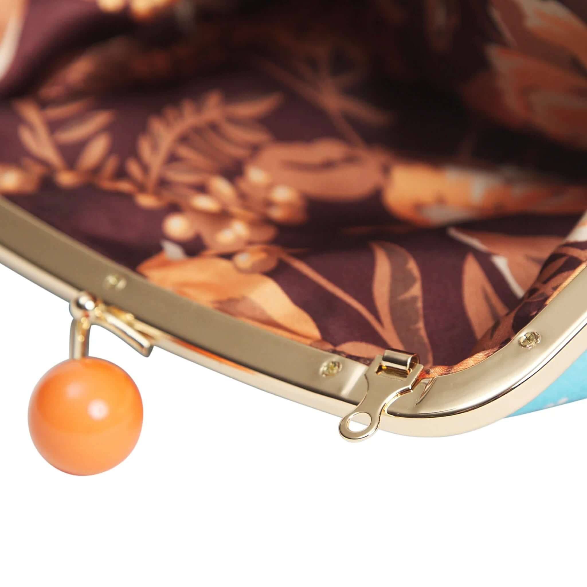 Inside view of the Sage x Clare Bonny Large Purse - Turquoise with a floral lining and coral bobble clasp.